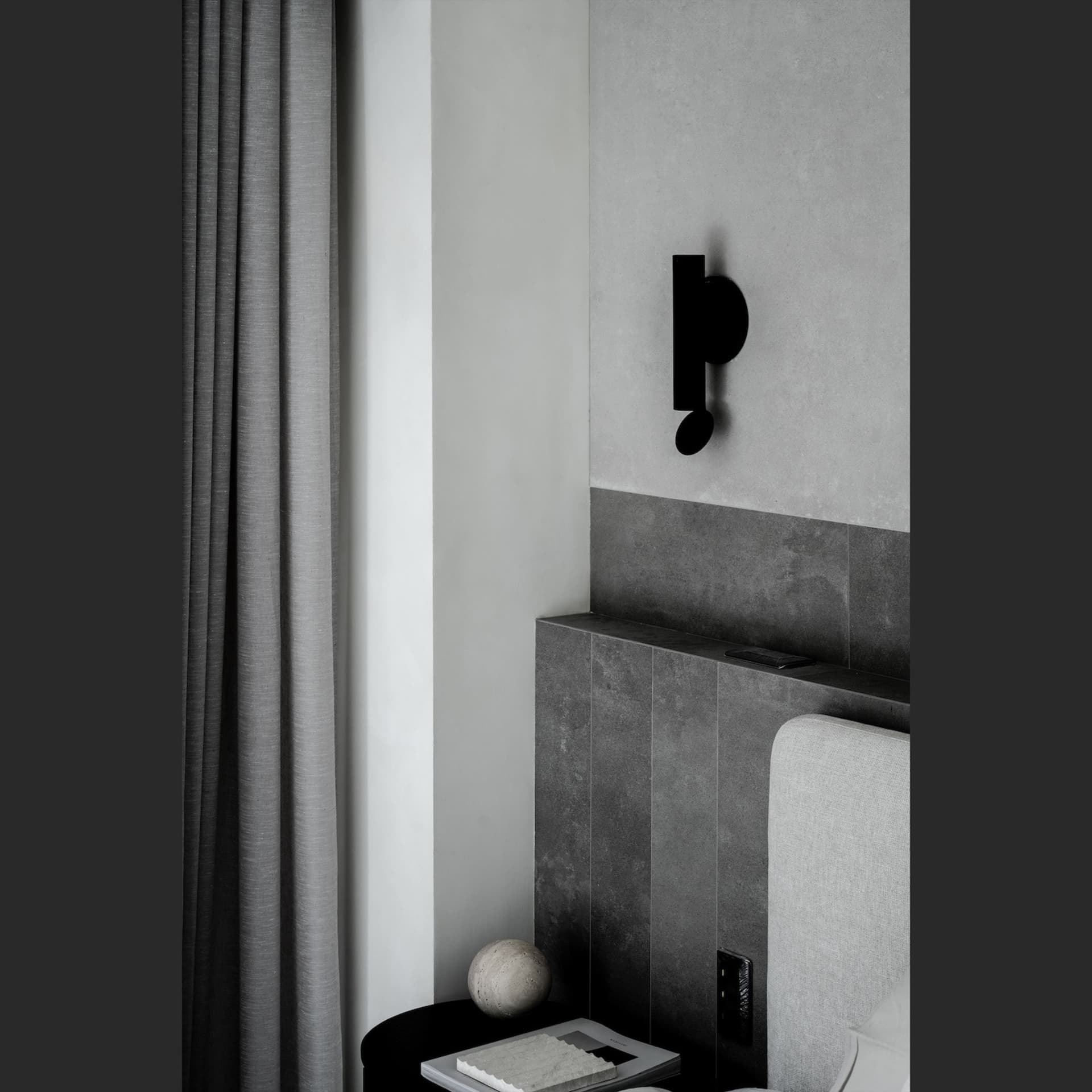 Modern minimalist bedroom featuring concrete walls