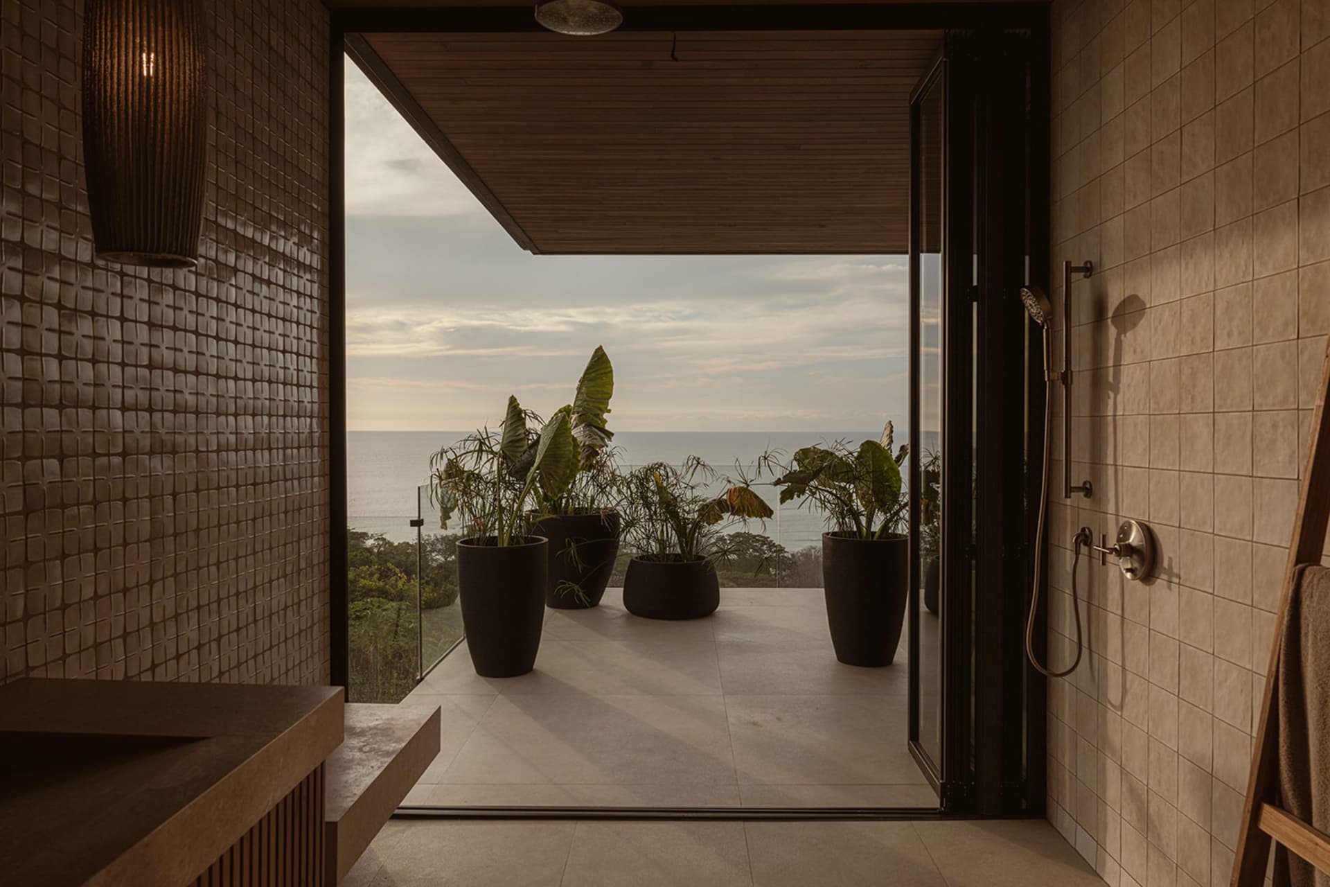 A minimalist balcony featuring concrete and glass elements.