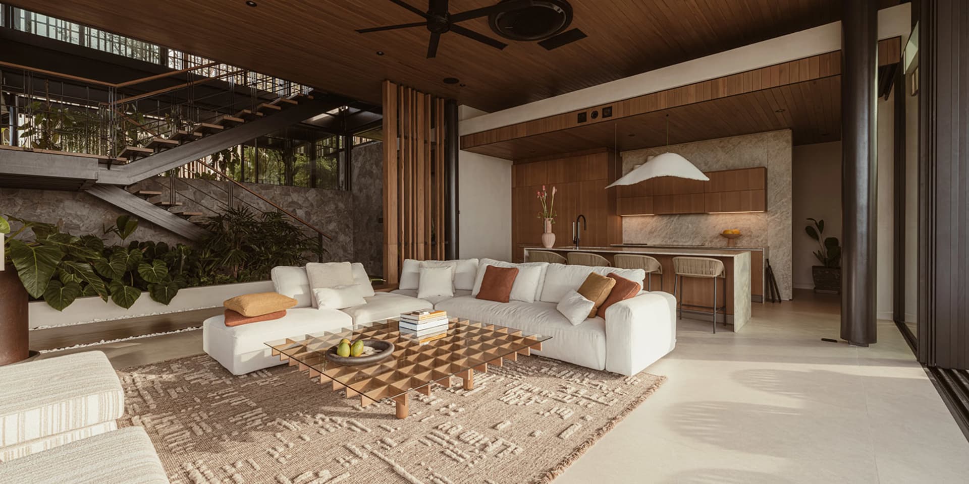 Modern minimalist living room with white furniture, marble accents, and wood elements.