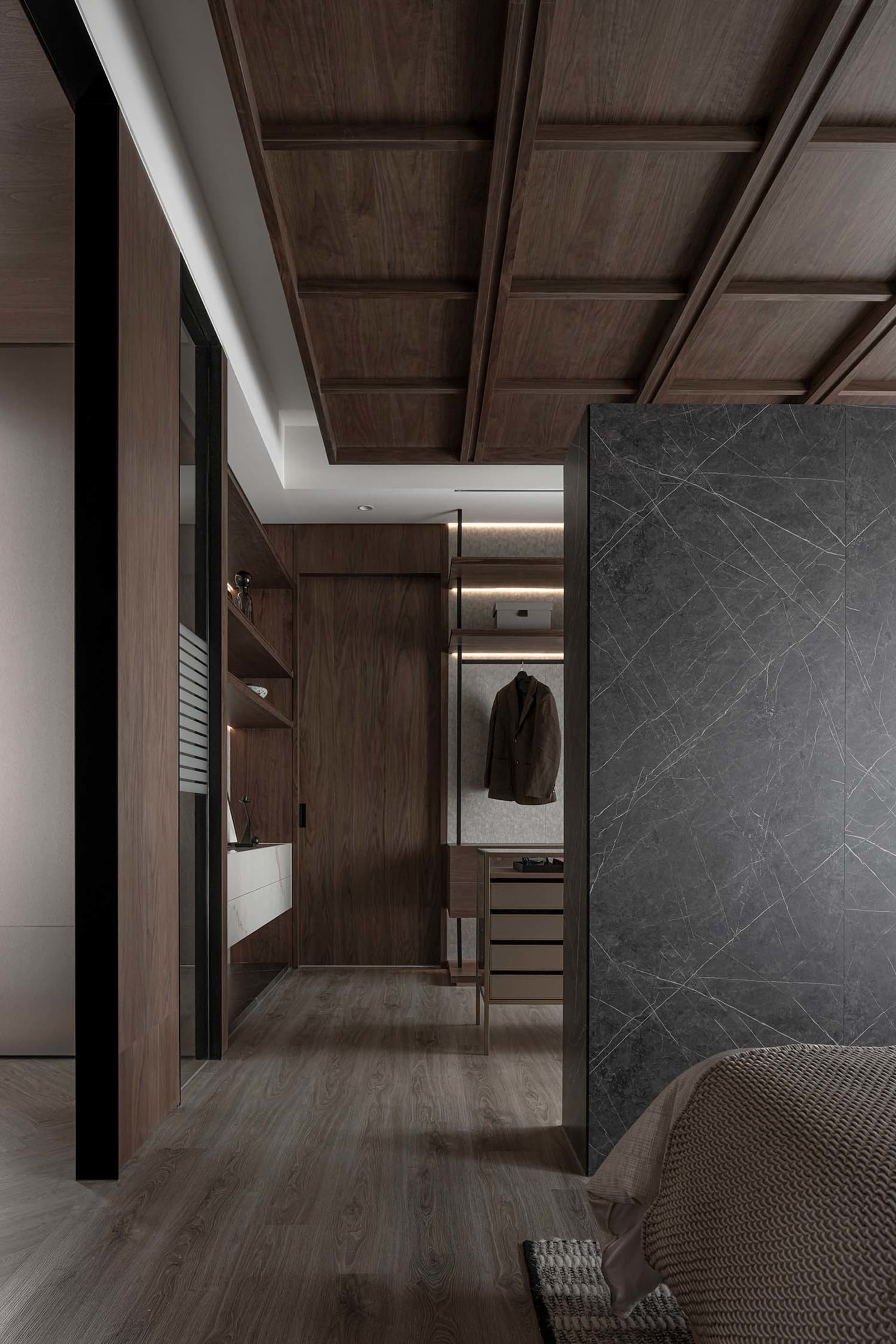 Modern closet with wooden paneling and LED lighting.