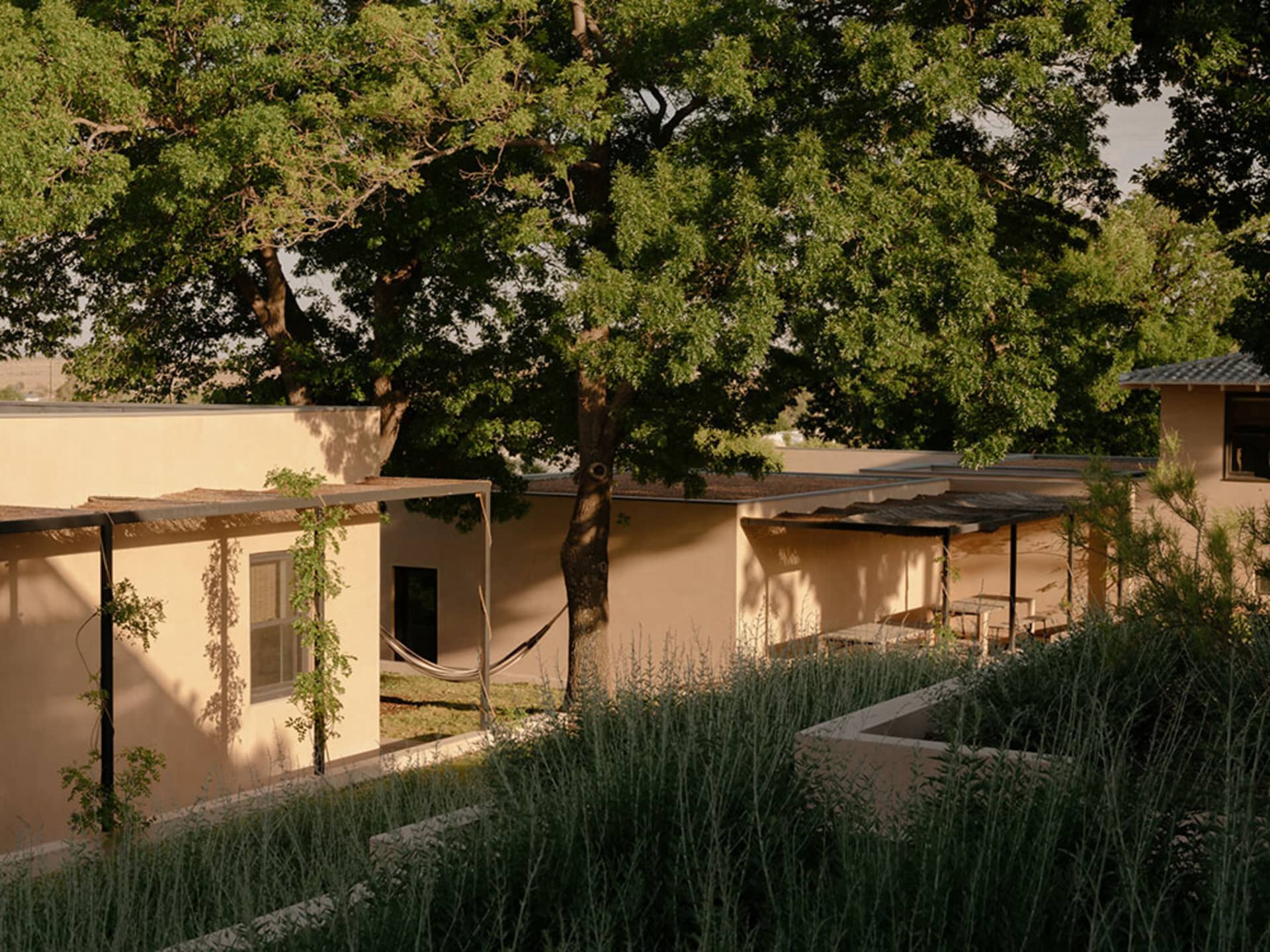 A modern architectural design featuring sandstone walls and a spacious, open layout.