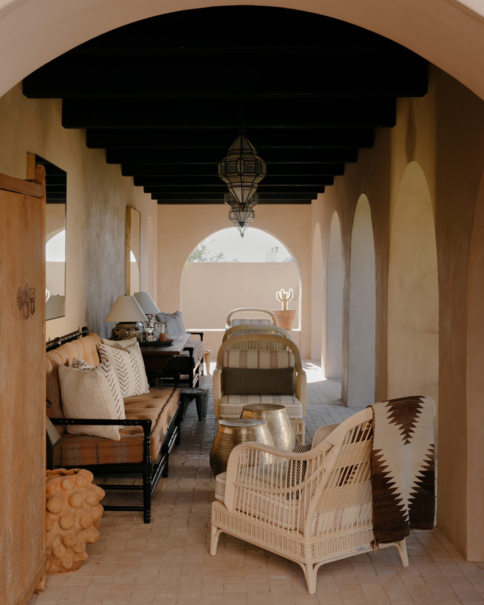 A cozy living room interior featuring natural fiber cotton textiles and wicker furniture.