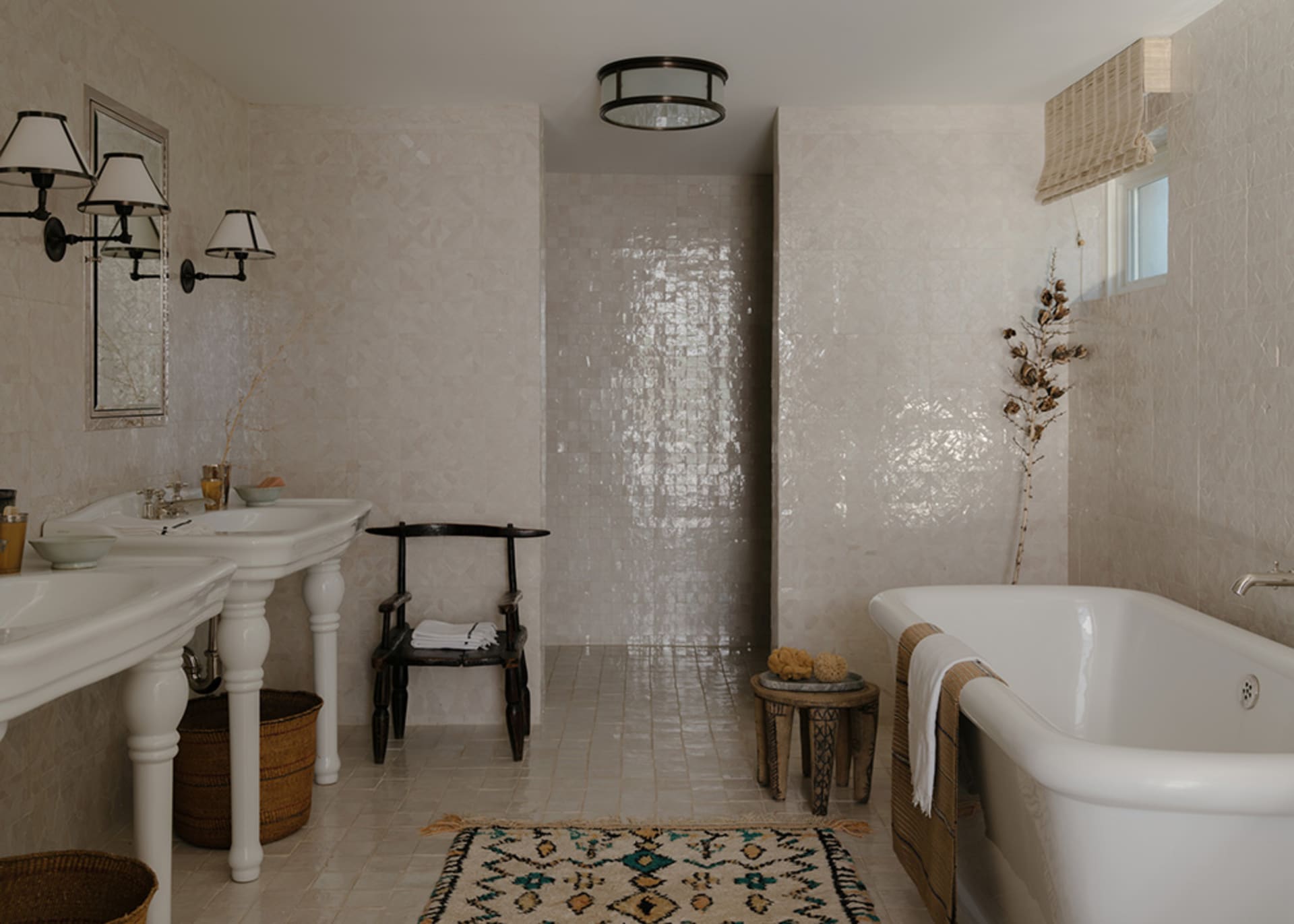 A modern bathroom with white tiles, a white bathtub, and decorative elements.