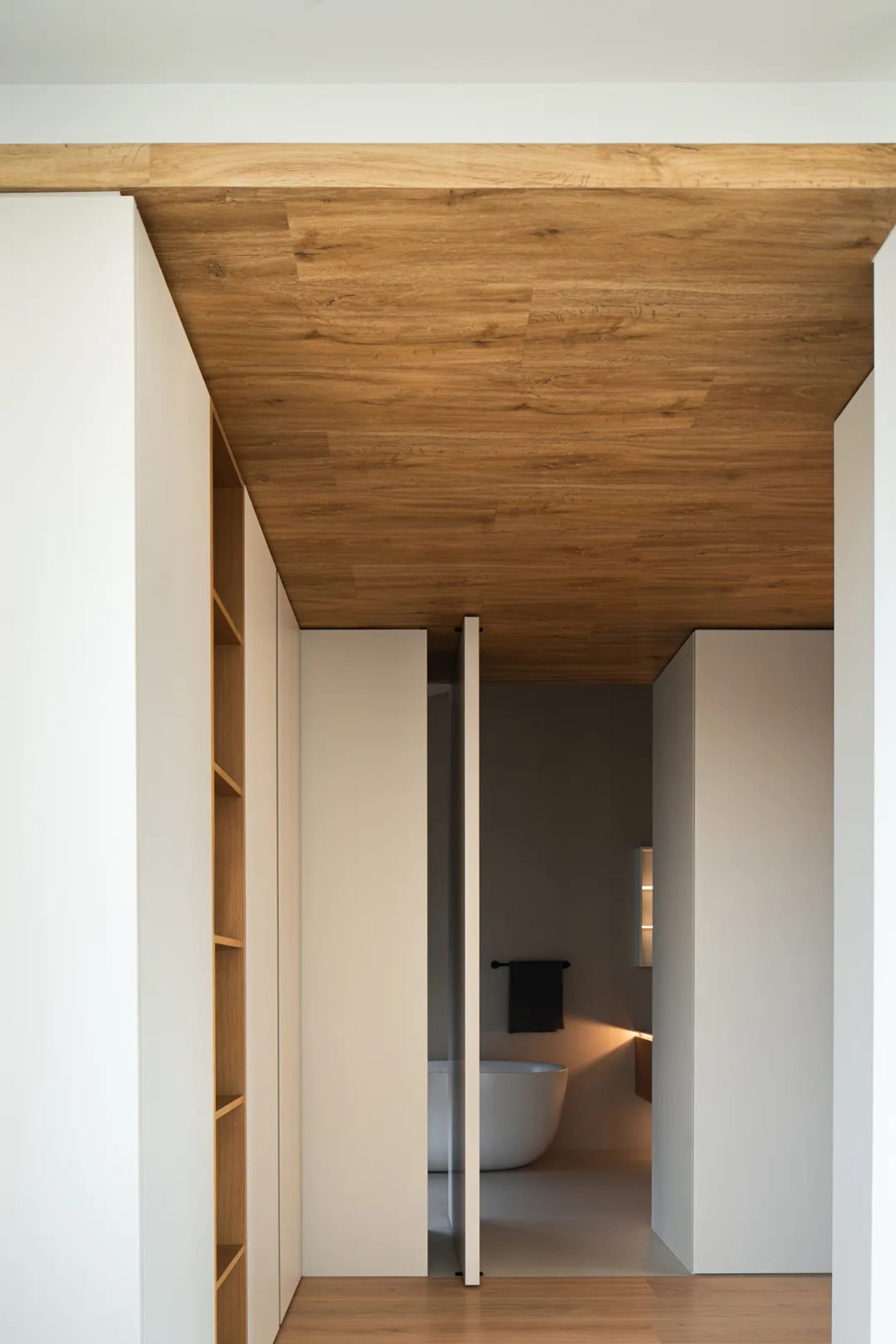 A minimalist interior design featuring wood cabinets and minimalist furniture.