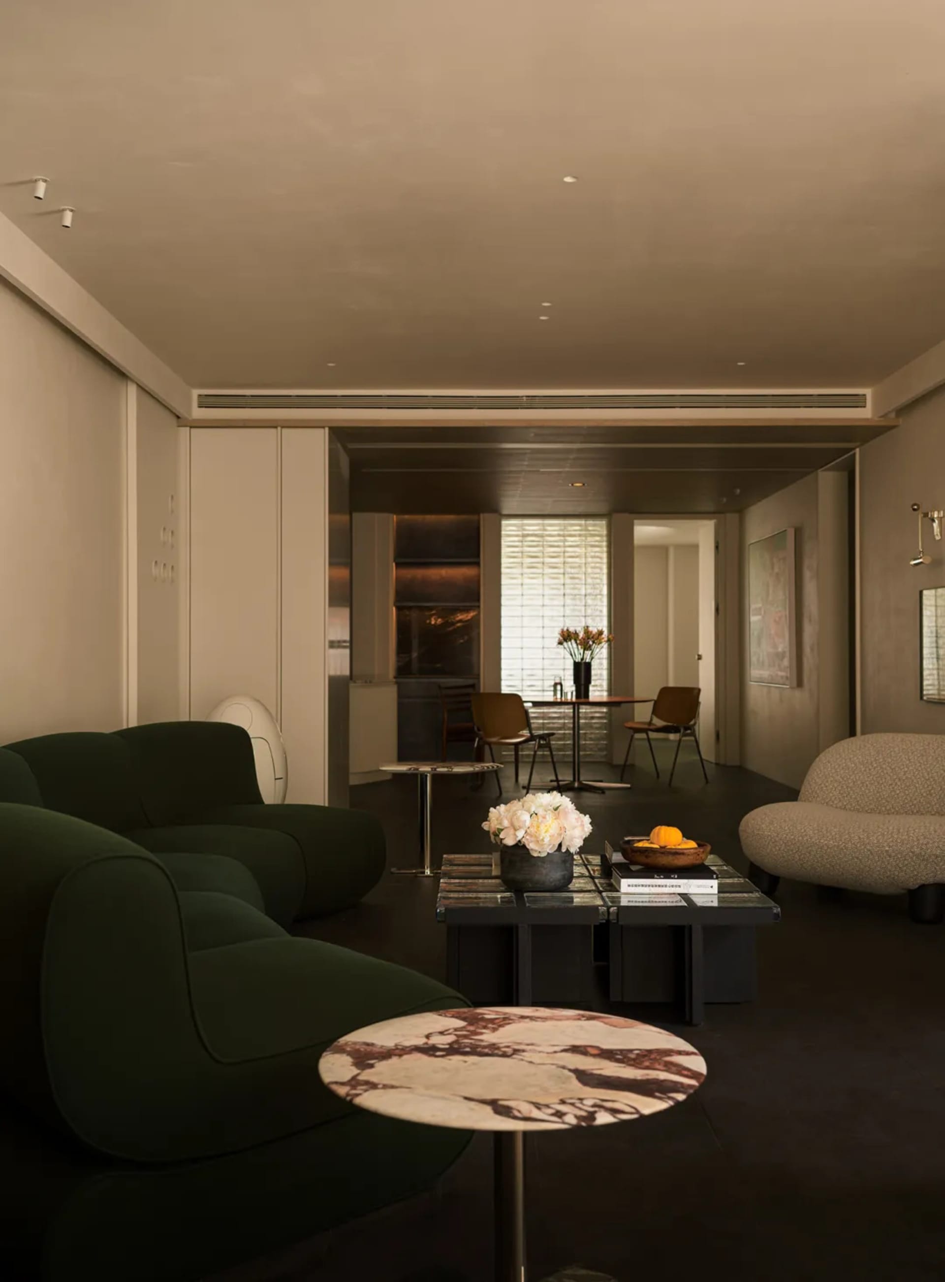 Modern minimalist living room featuring contemporary furniture in marble and concrete finishes.
