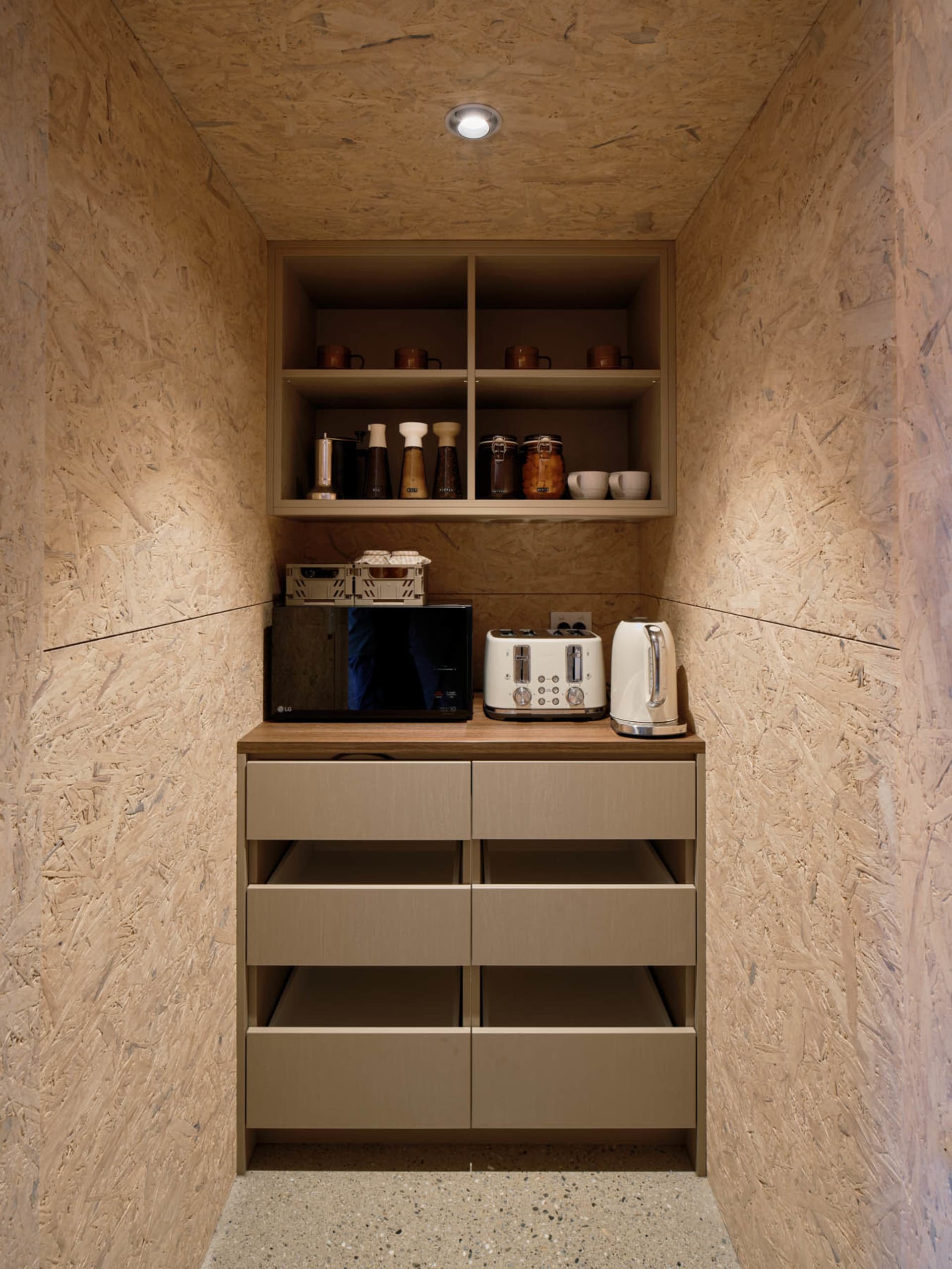 A modern kitchen with wooden cabinets, cupboards, and drawers.