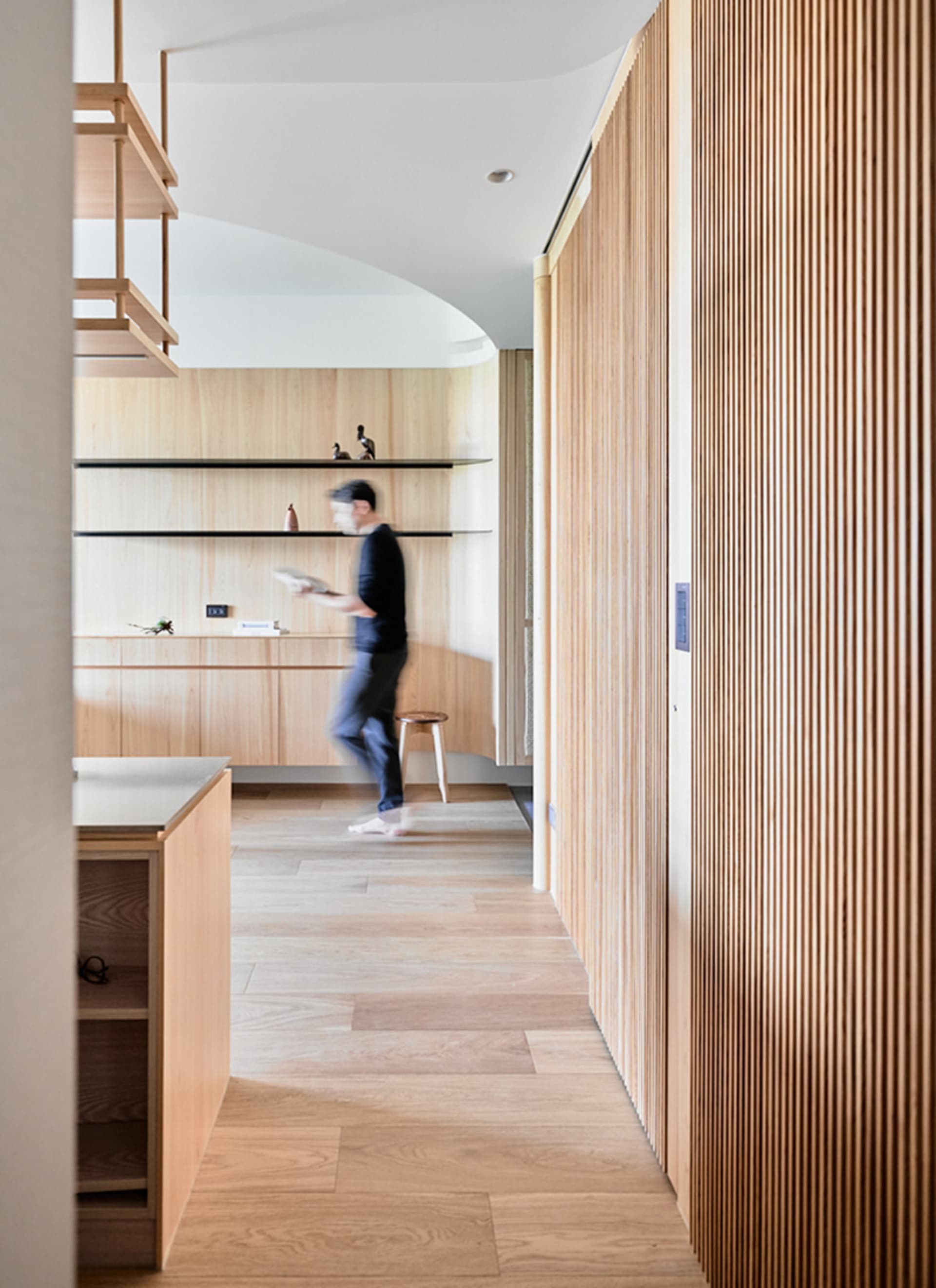 A modern kitchen featuring wooden cabinets and a minimalist design.