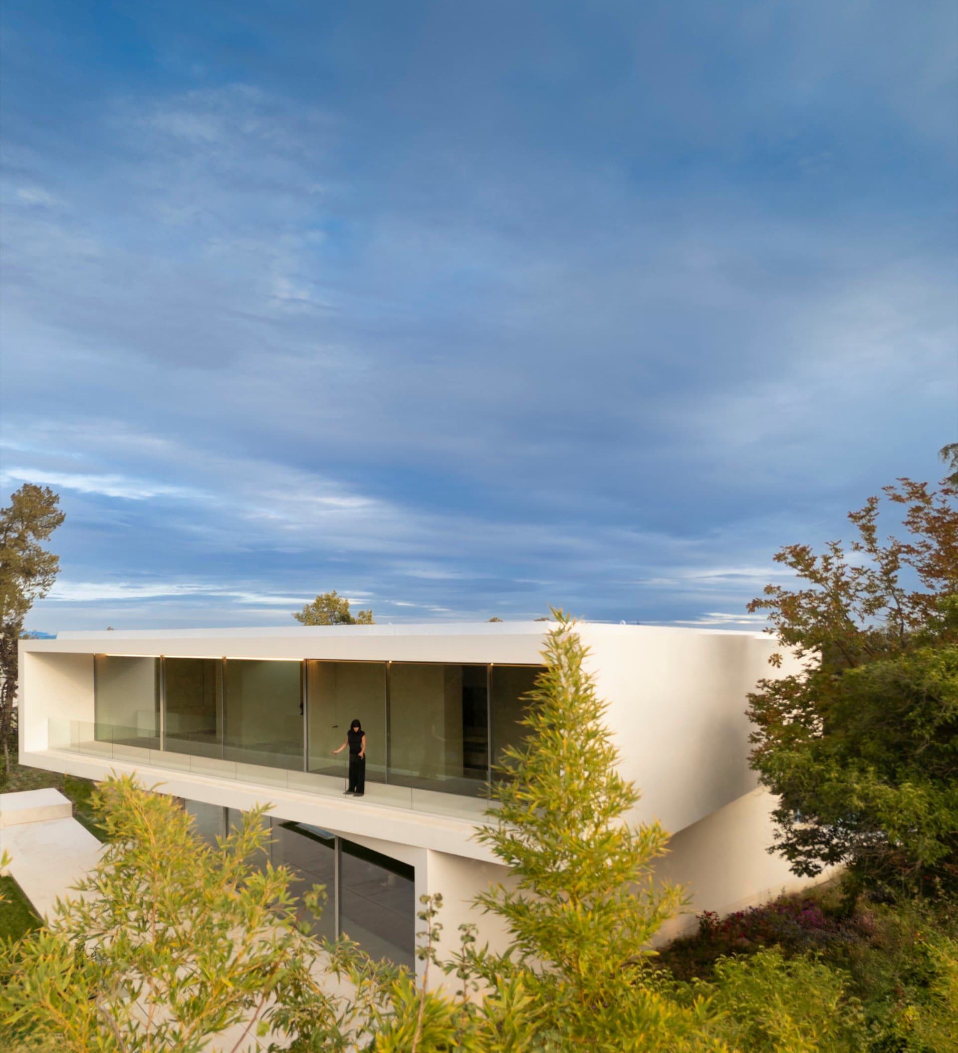 Modern house with large glass windows and white exterior walls
