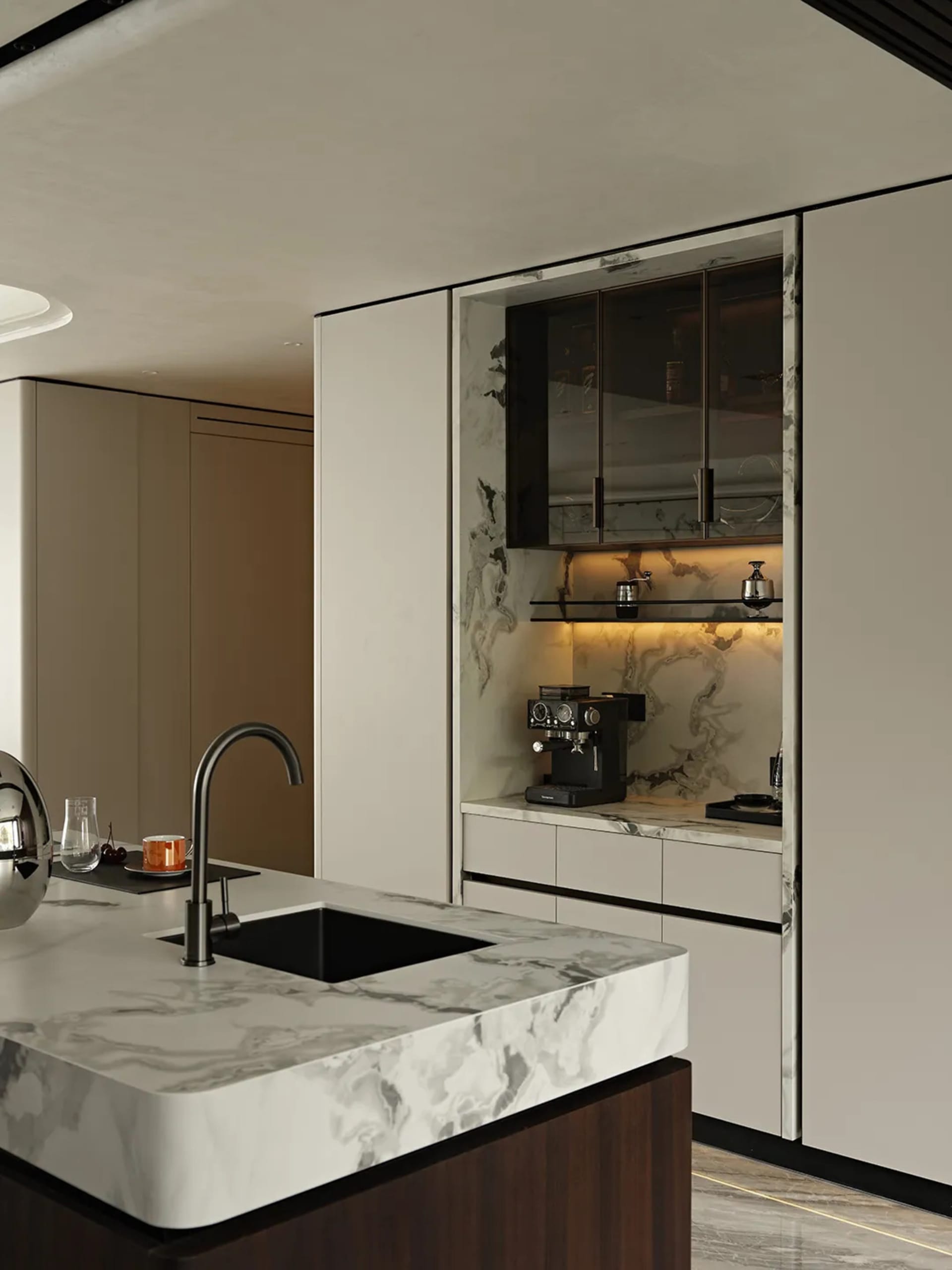 Modern kitchen interior with marble countertops, fruit bowls, and minimalist design.