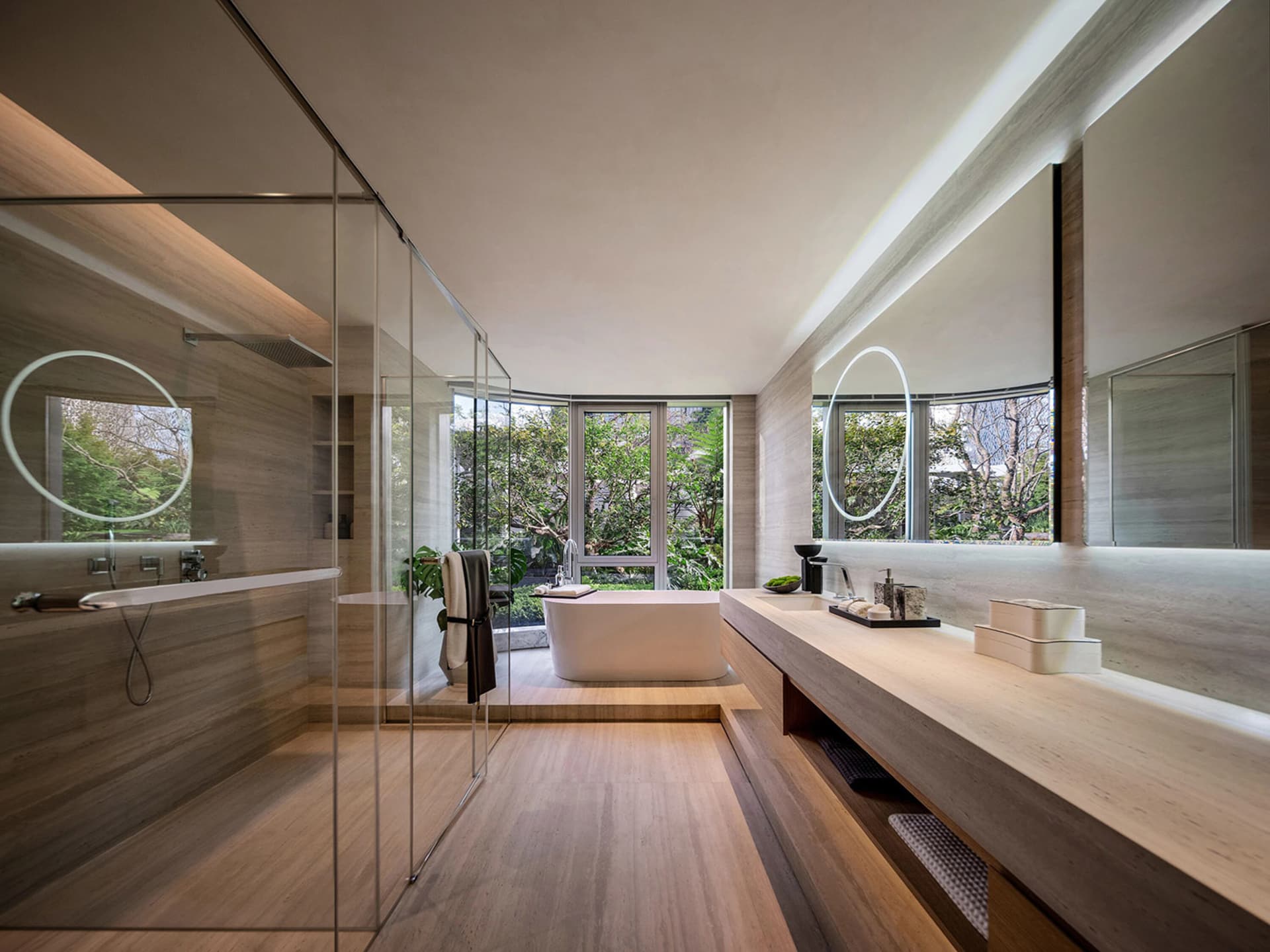 A modern minimalist bathroom with a freestanding bathtub, glass shower enclosure, and wooden flooring and fixtures.