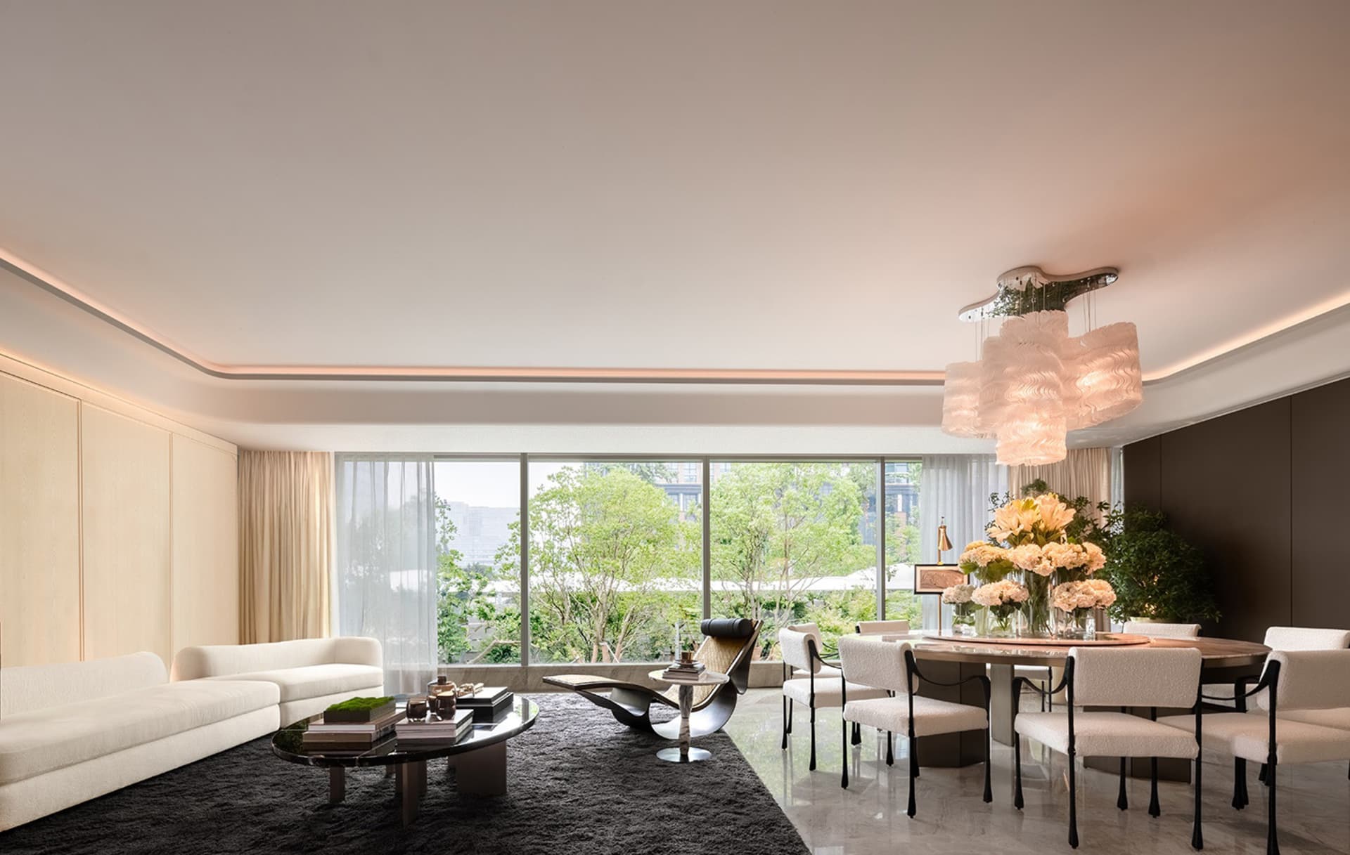 Modern residential lounge with white furniture and glass windows