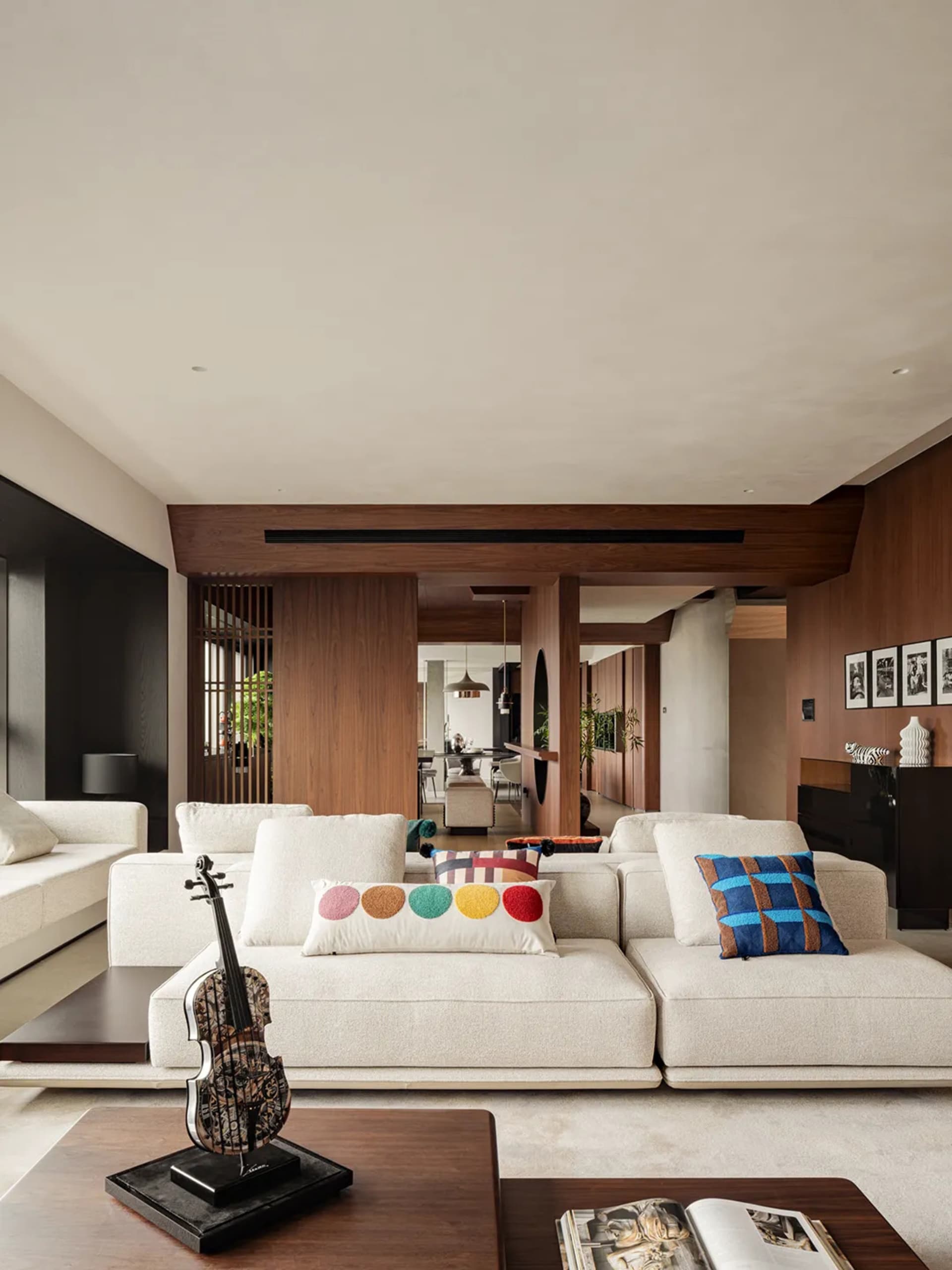A minimalist living room with modern furniture, a white sofa, and decorative pillows.