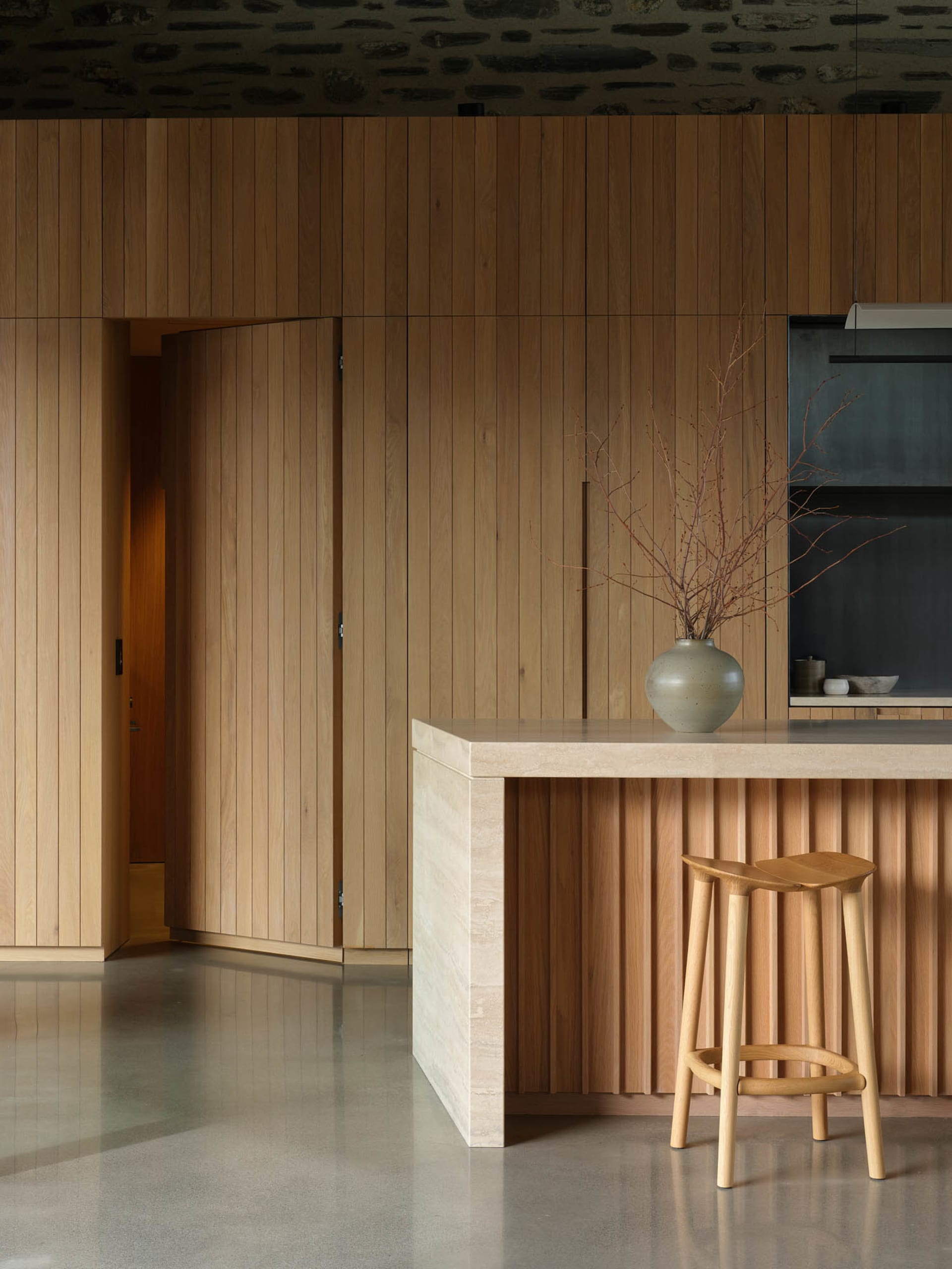 A modern residential kitchen featuring a wooden counter and floor.