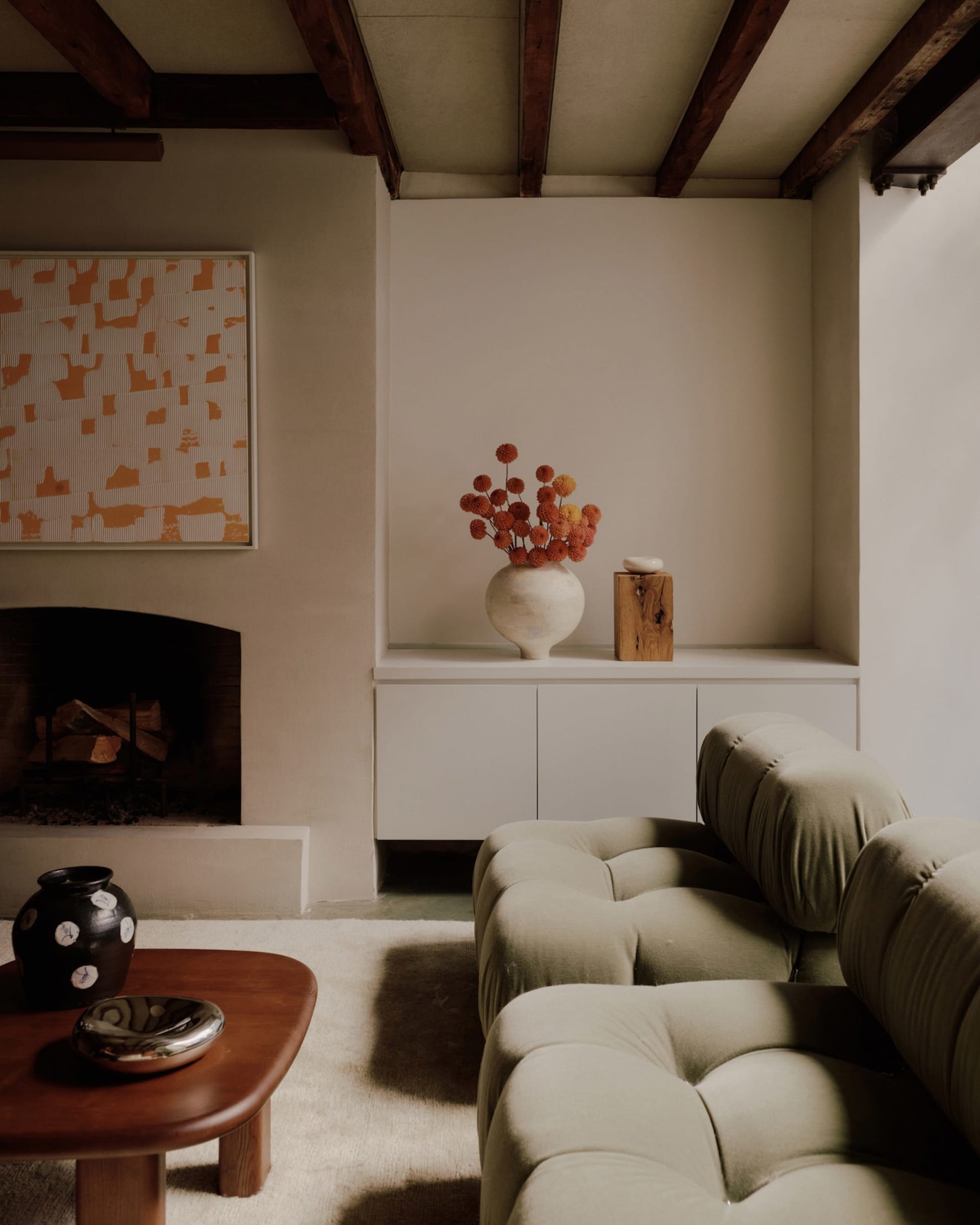 A cozy industrial-style living room featuring plush upholstered furniture and concrete accents