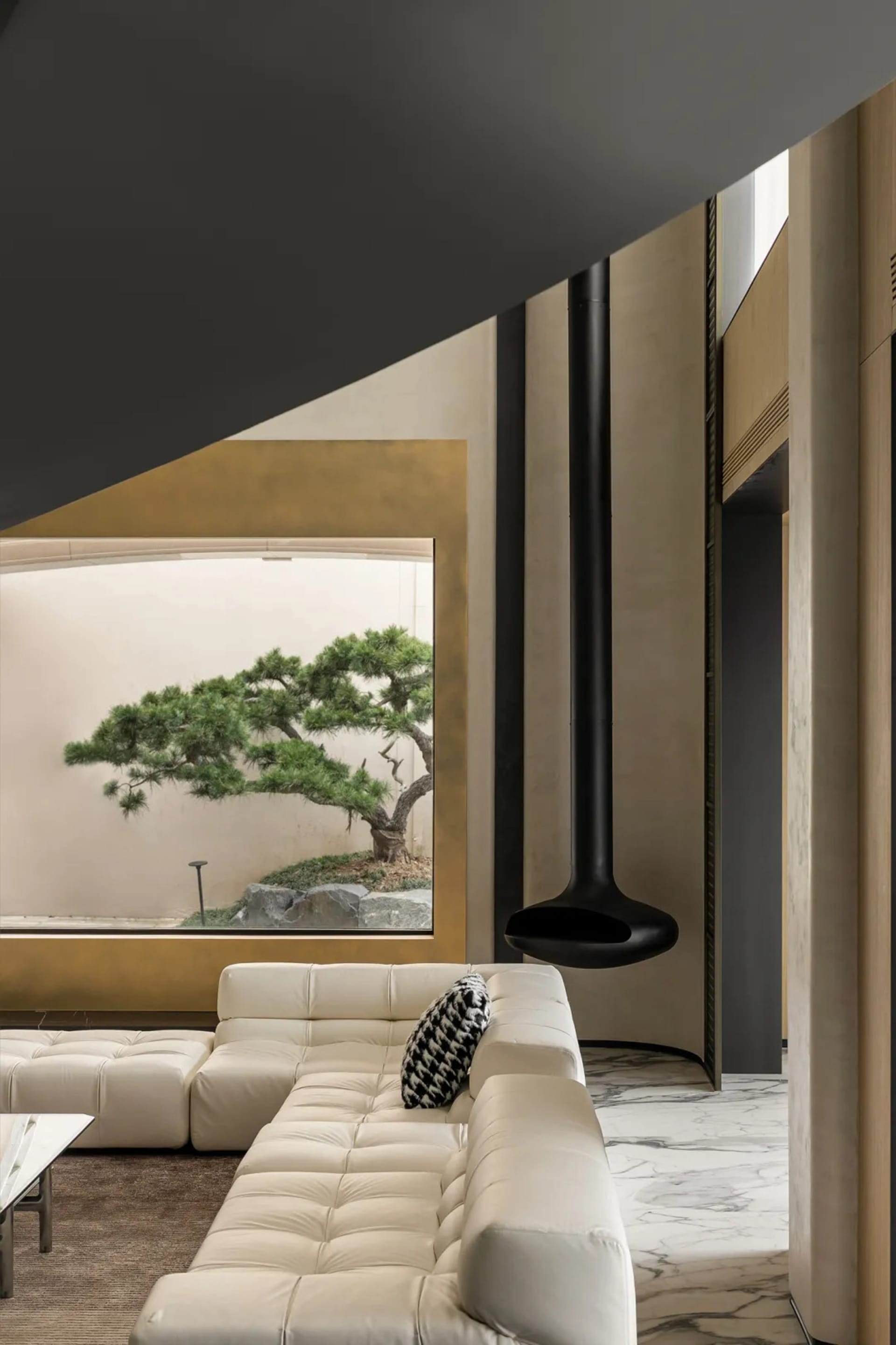 Modern minimalist living room with white leather sectional sofa, plants, and floating fireplace in contemporary design
