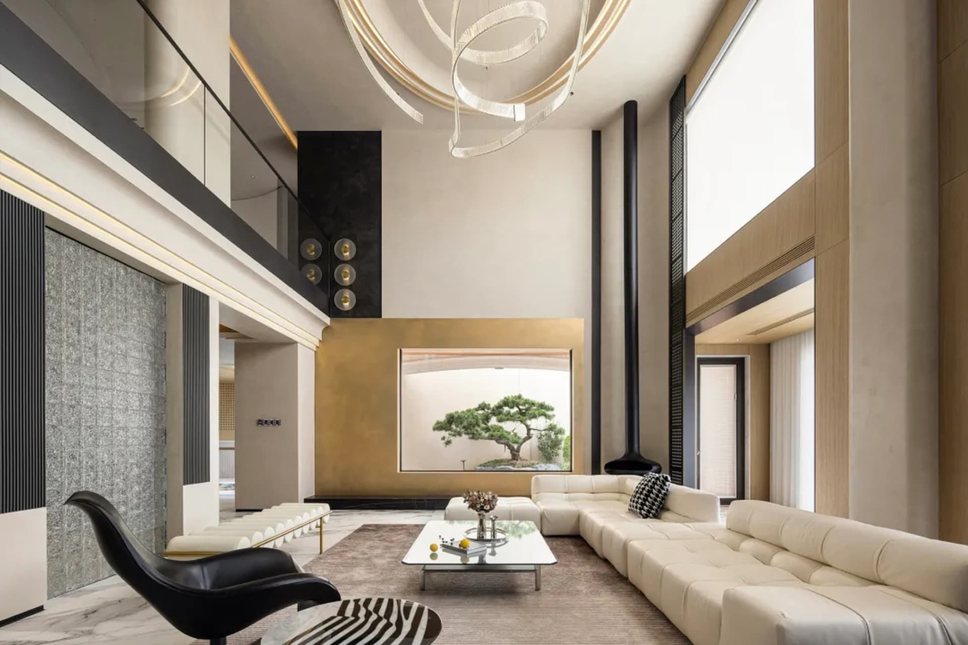 Contemporary living room with concrete walls, white sofa, and black accent chair.
