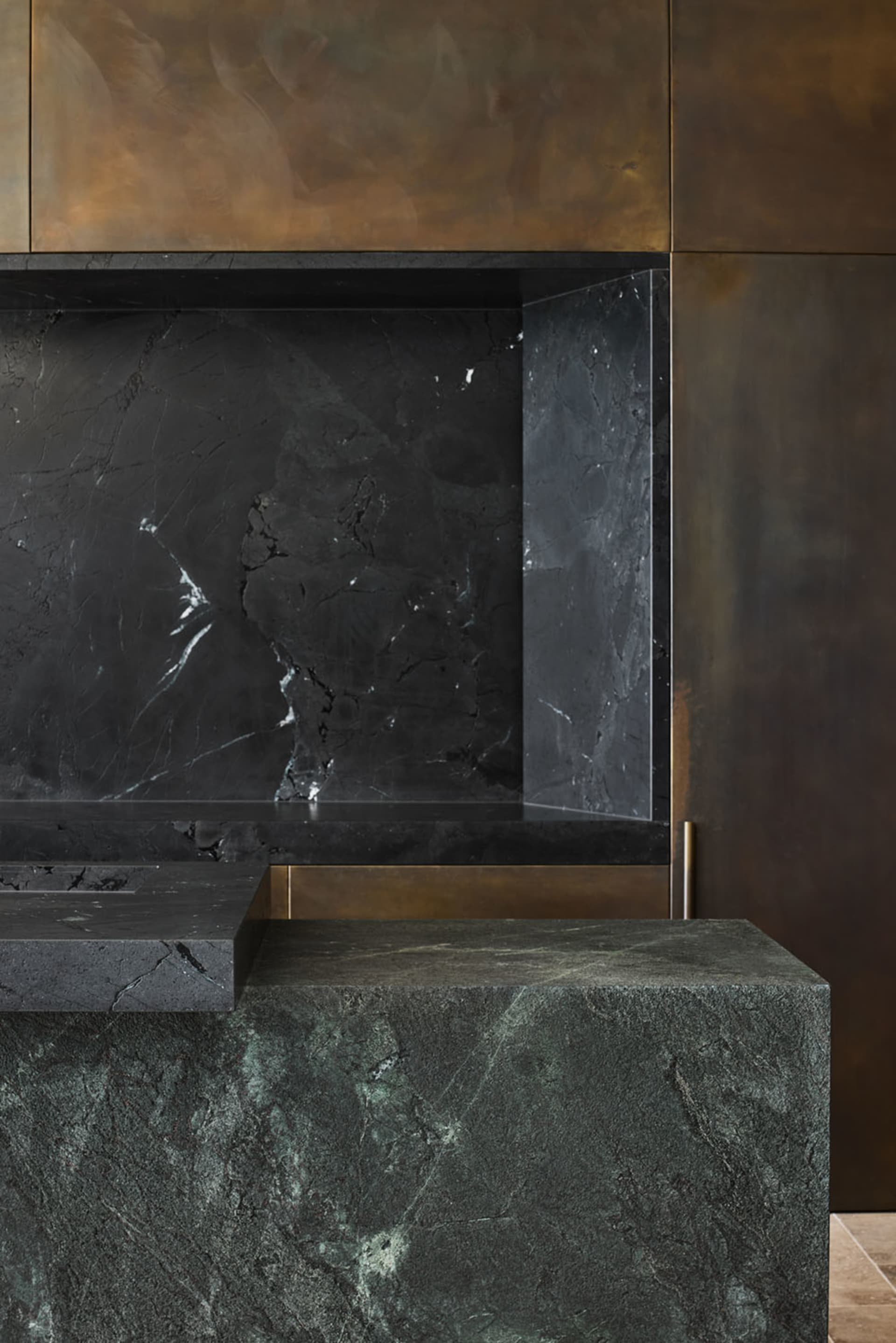 A modern kitchen featuring a black marble countertop and a black marble backsplash.