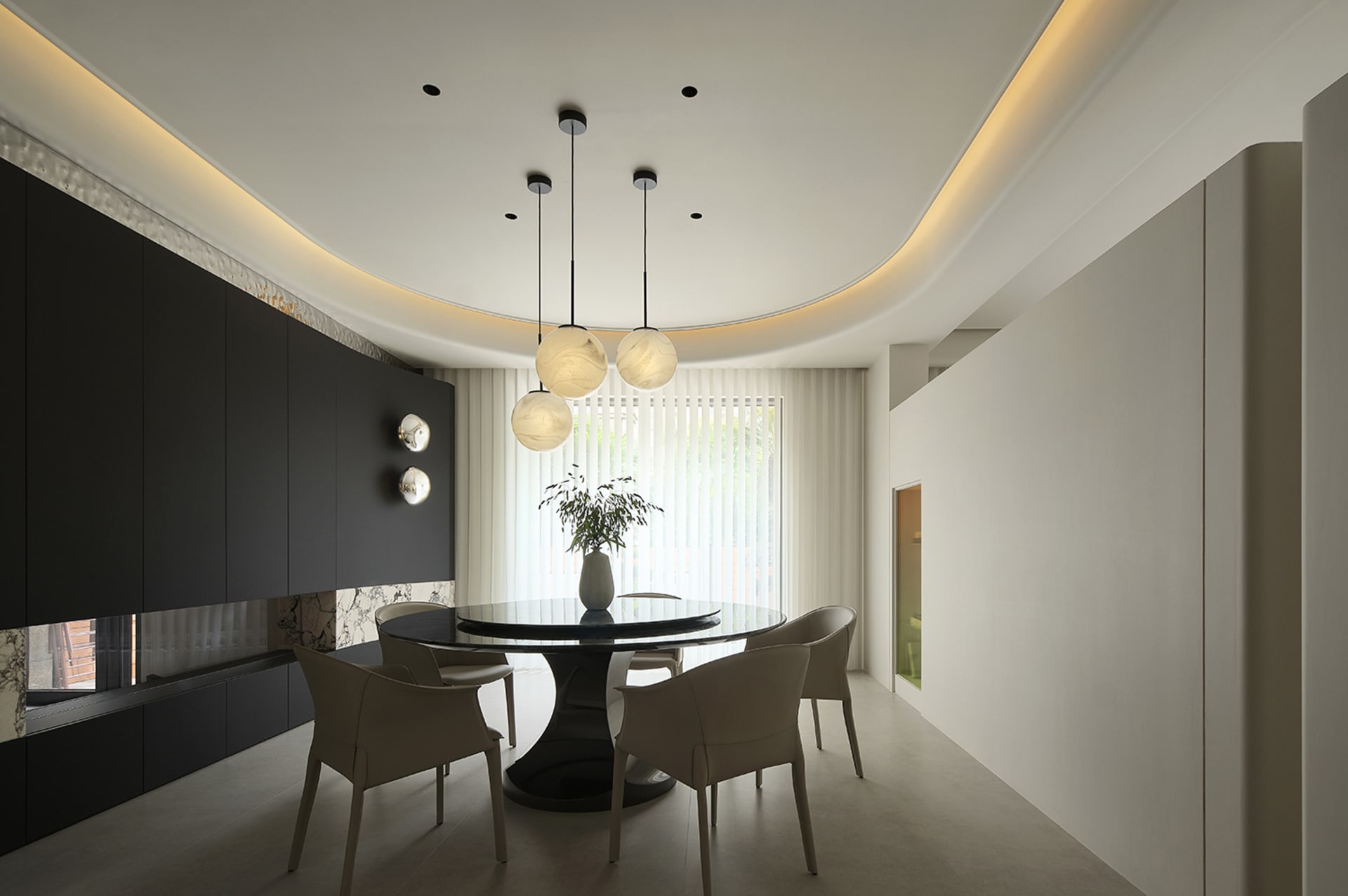 Modern dining room featuring metallic pendant lights