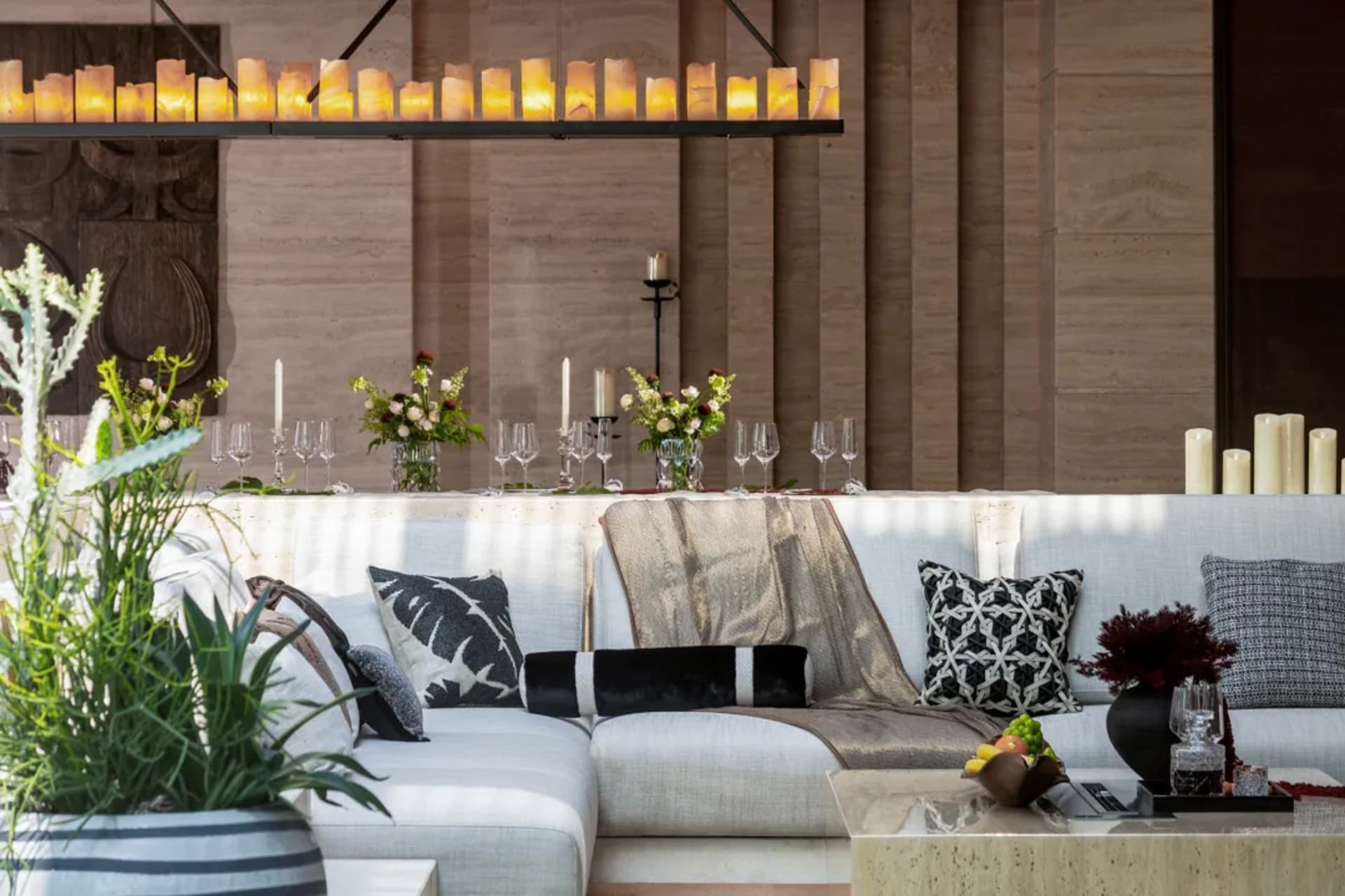 A modern living room featuring luxurious candles, stylish decorations, and comfortable seating arrangements.