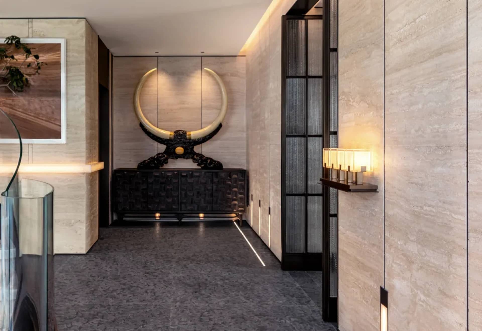 Modern entrance hall with marble flooring, walls, and large decorative bull horns