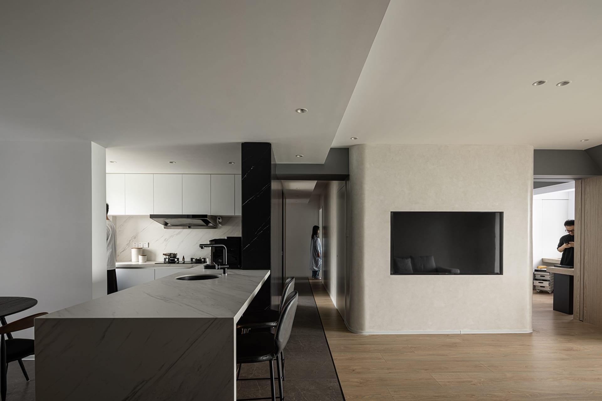 Modern kitchen with marble countertops and concrete accents.