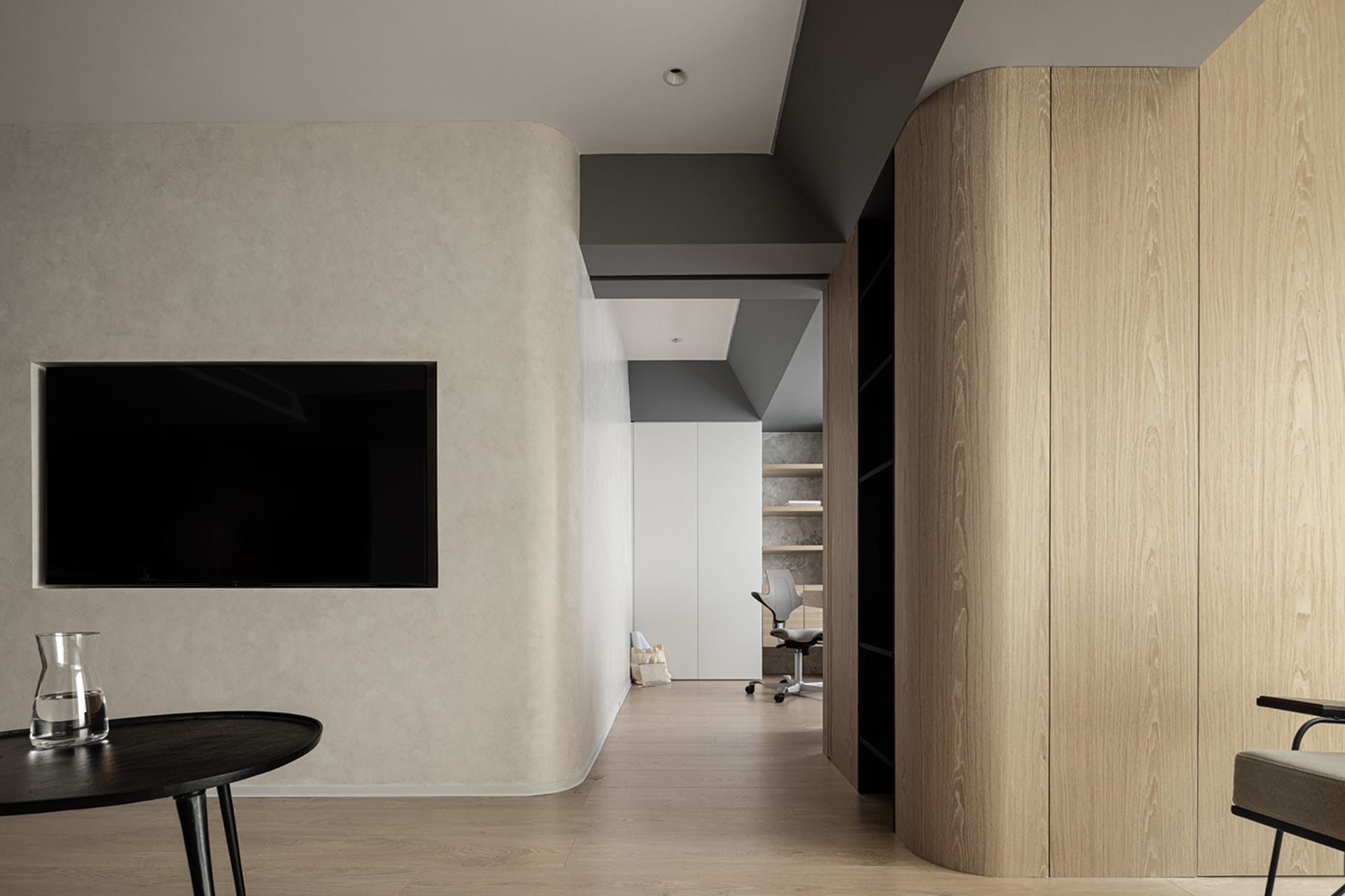 A minimalist office space featuring wood-paneled walls and a simple, sleek design.