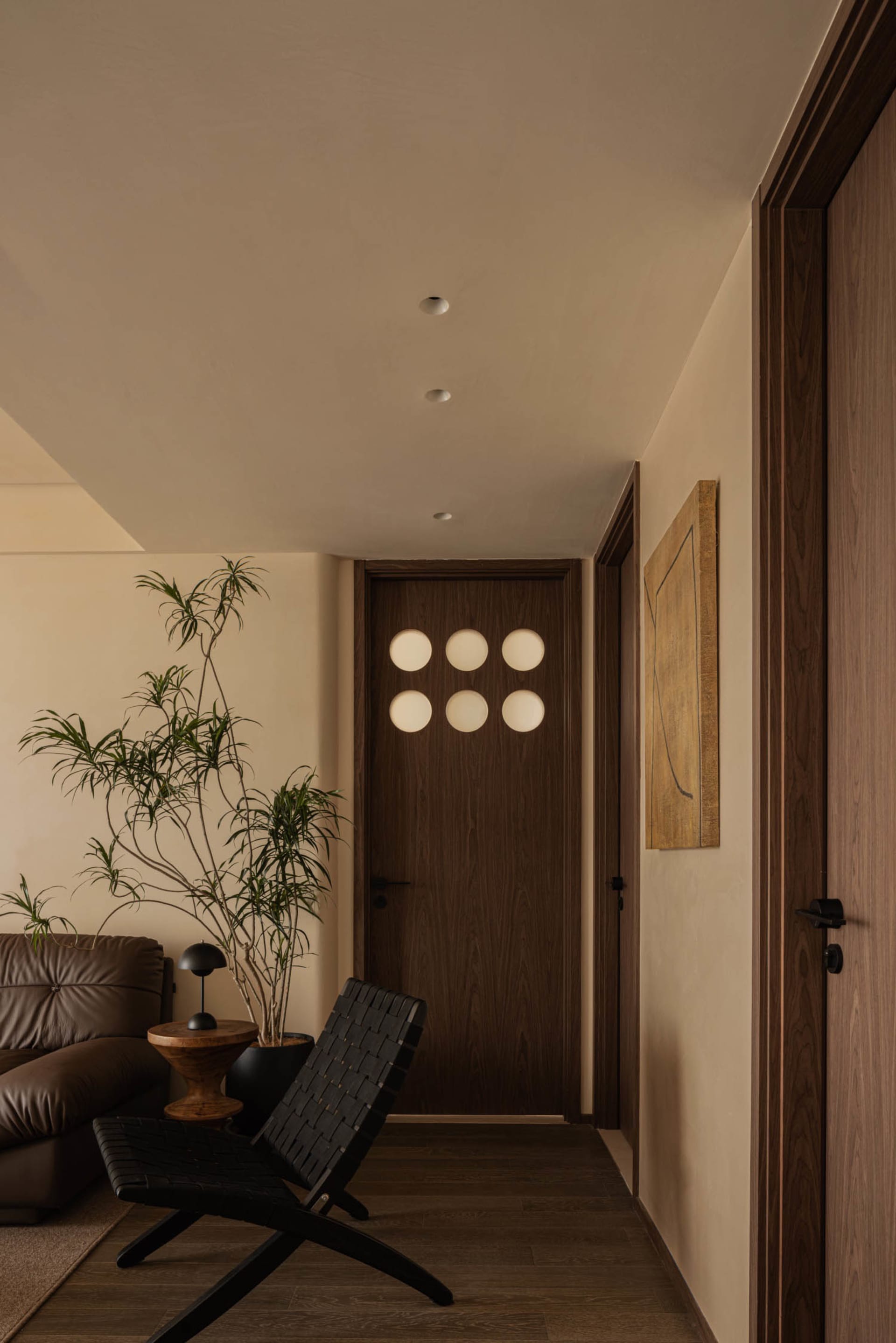 A modern living room with wooden furniture and a minimalist design aesthetic