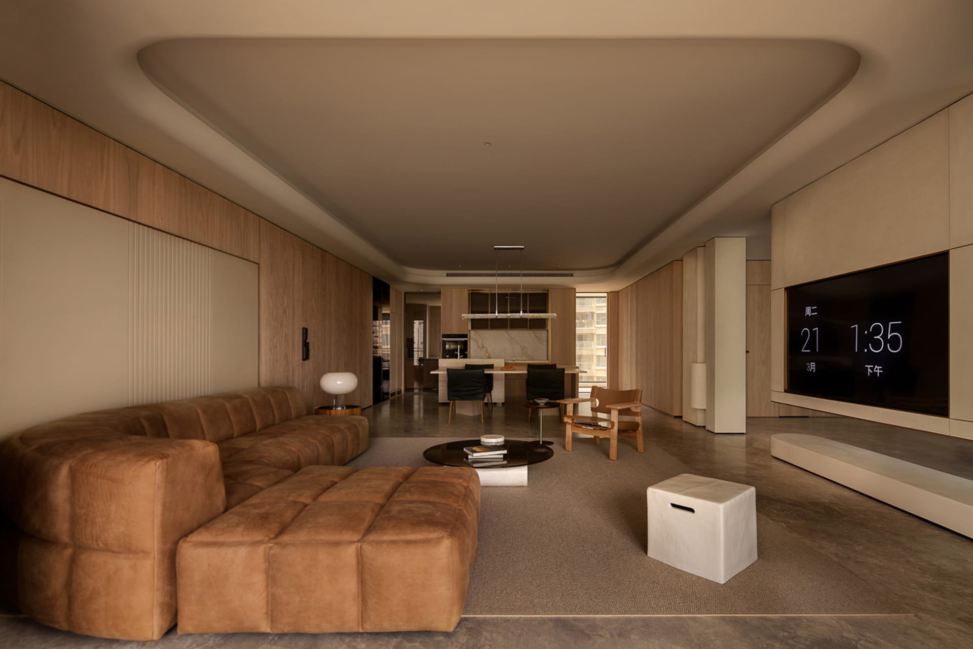 A minimalist living room with a large window overlooking a cityscape, featuring a comfortable sofa, a coffee table, and a boo