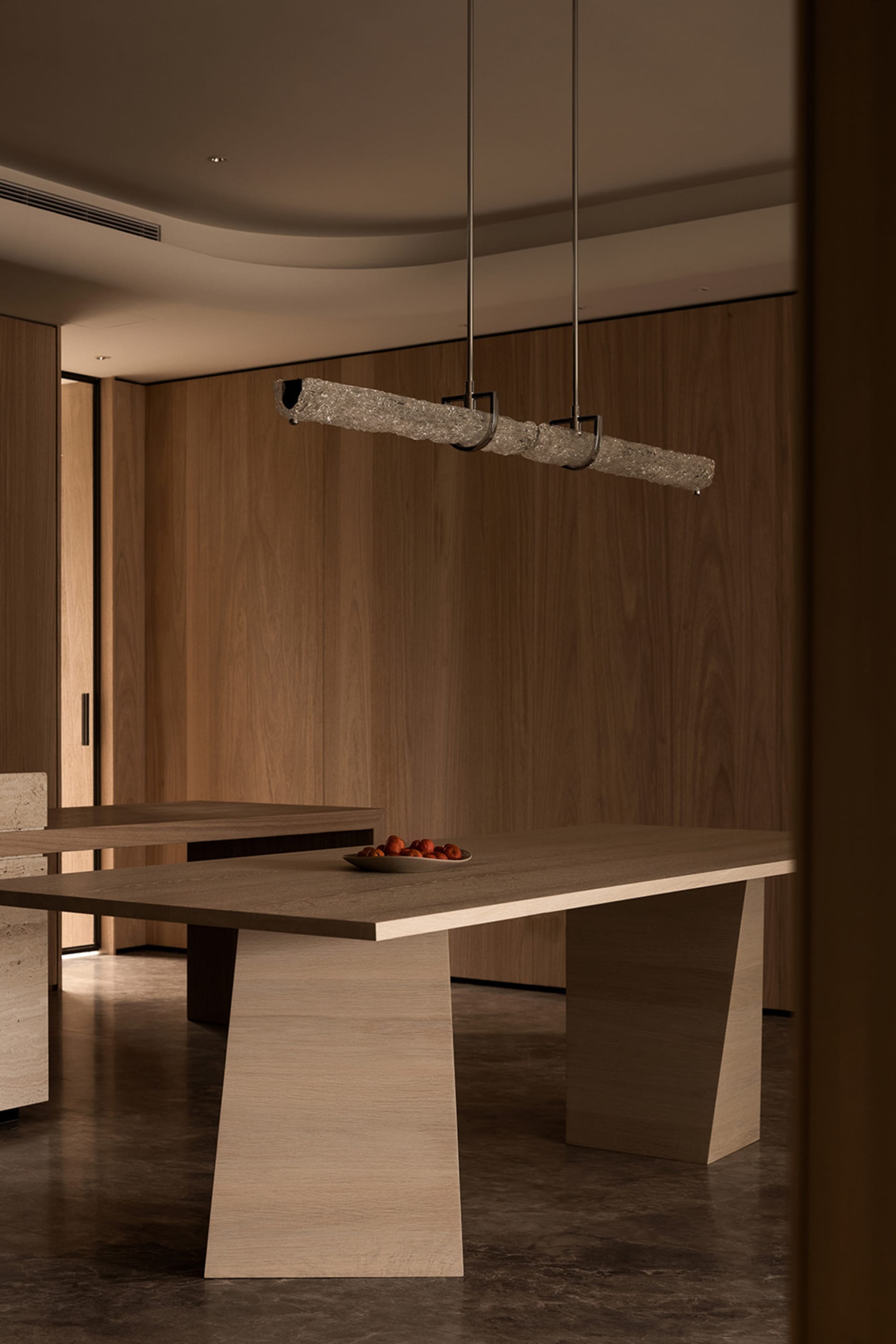 Modern minimalistic dining room featuring wooden tables and wood-paneled walls.
