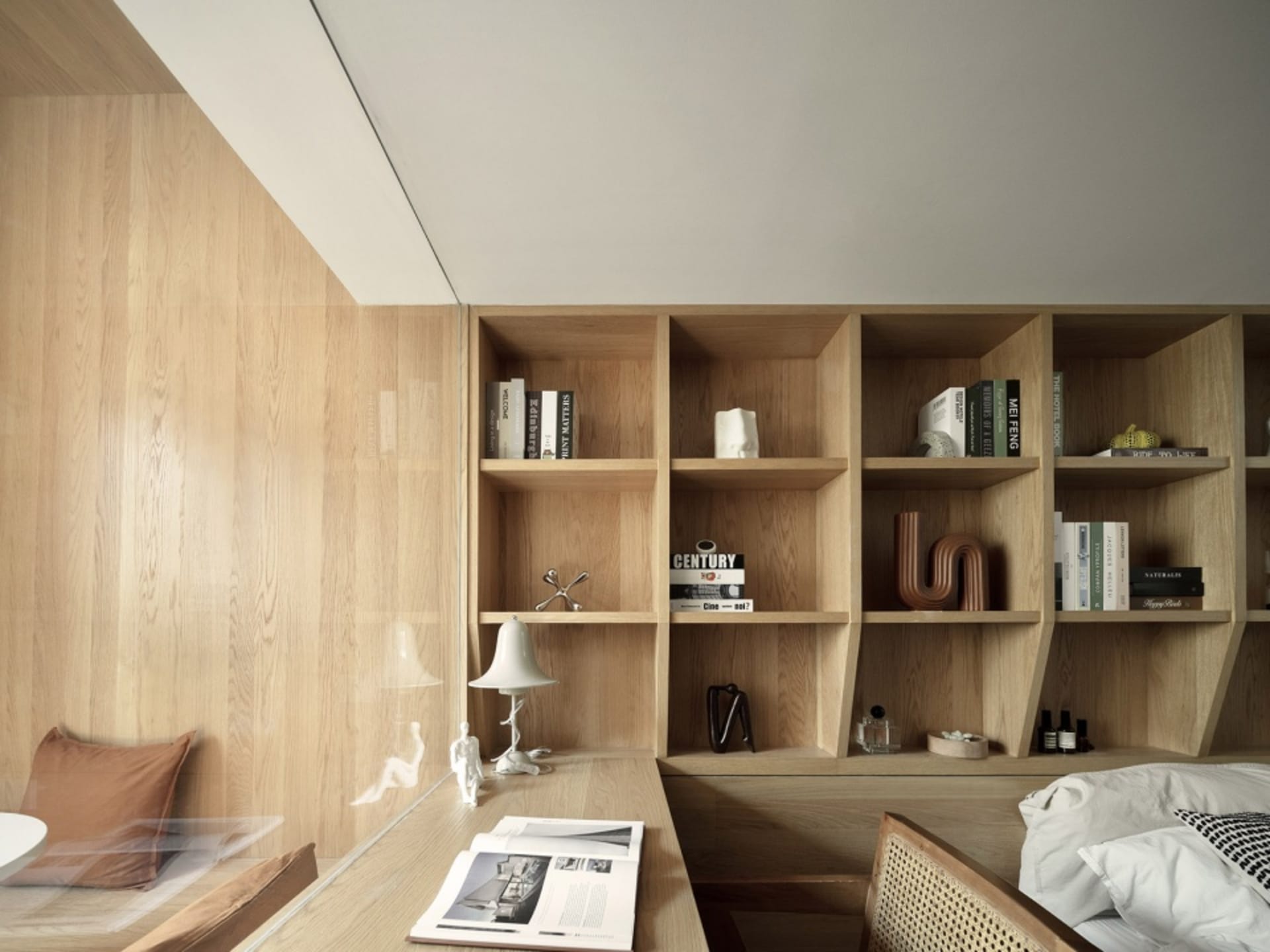 Modern bedroom with wooden walls, slanted ceiling, and single bed