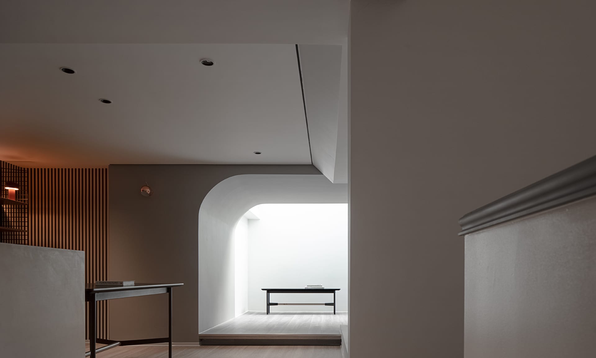 Modern lobby area with white and concrete finishes.