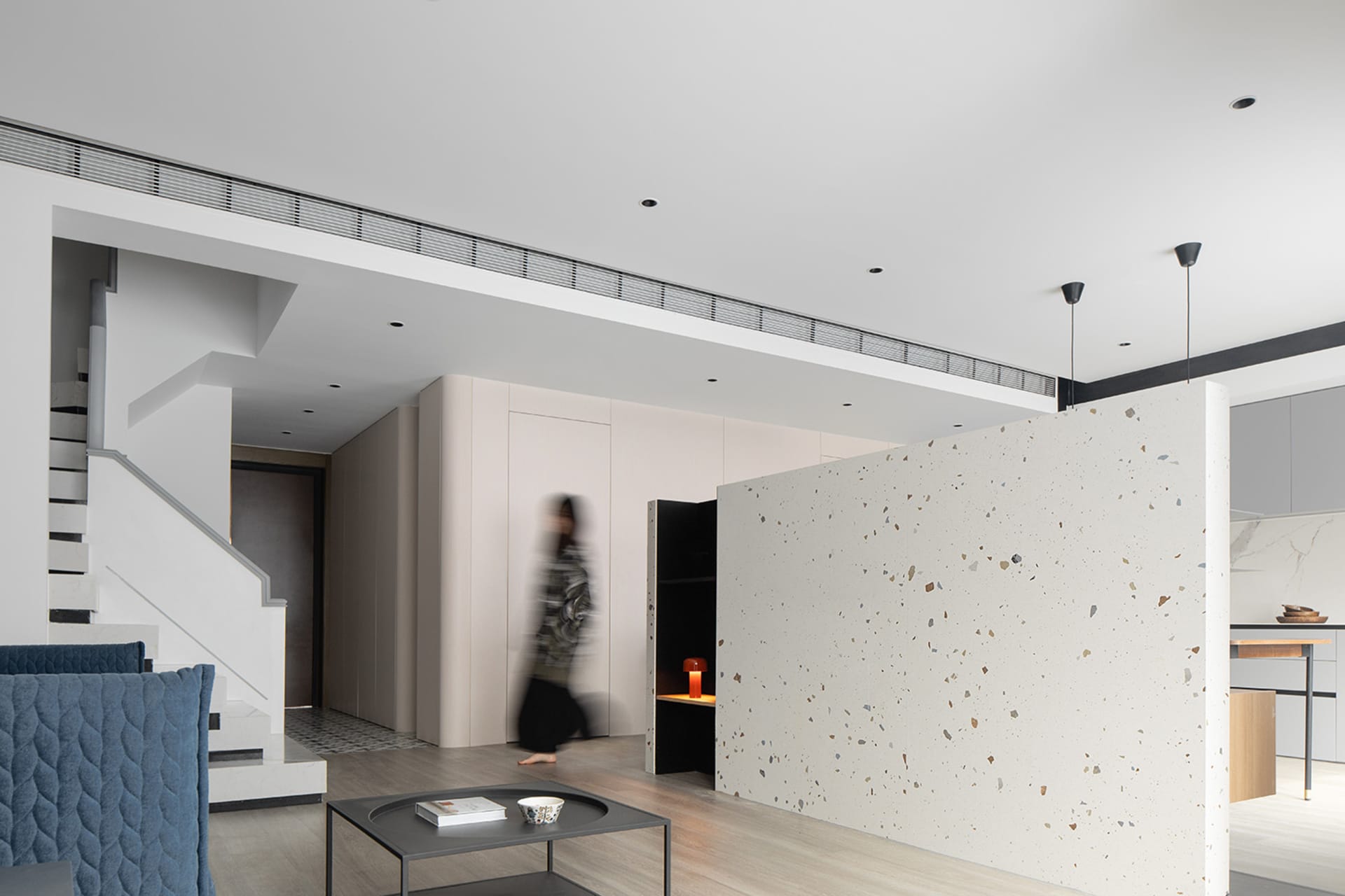 A modern interior featuring a terrazzo floor and minimalist design.