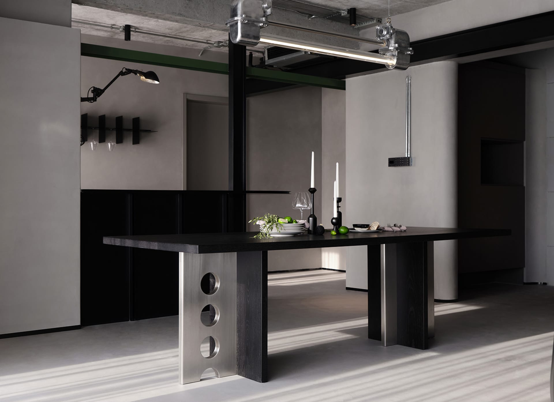Modern dining room featuring a metal table with white flooring and a minimalist design.