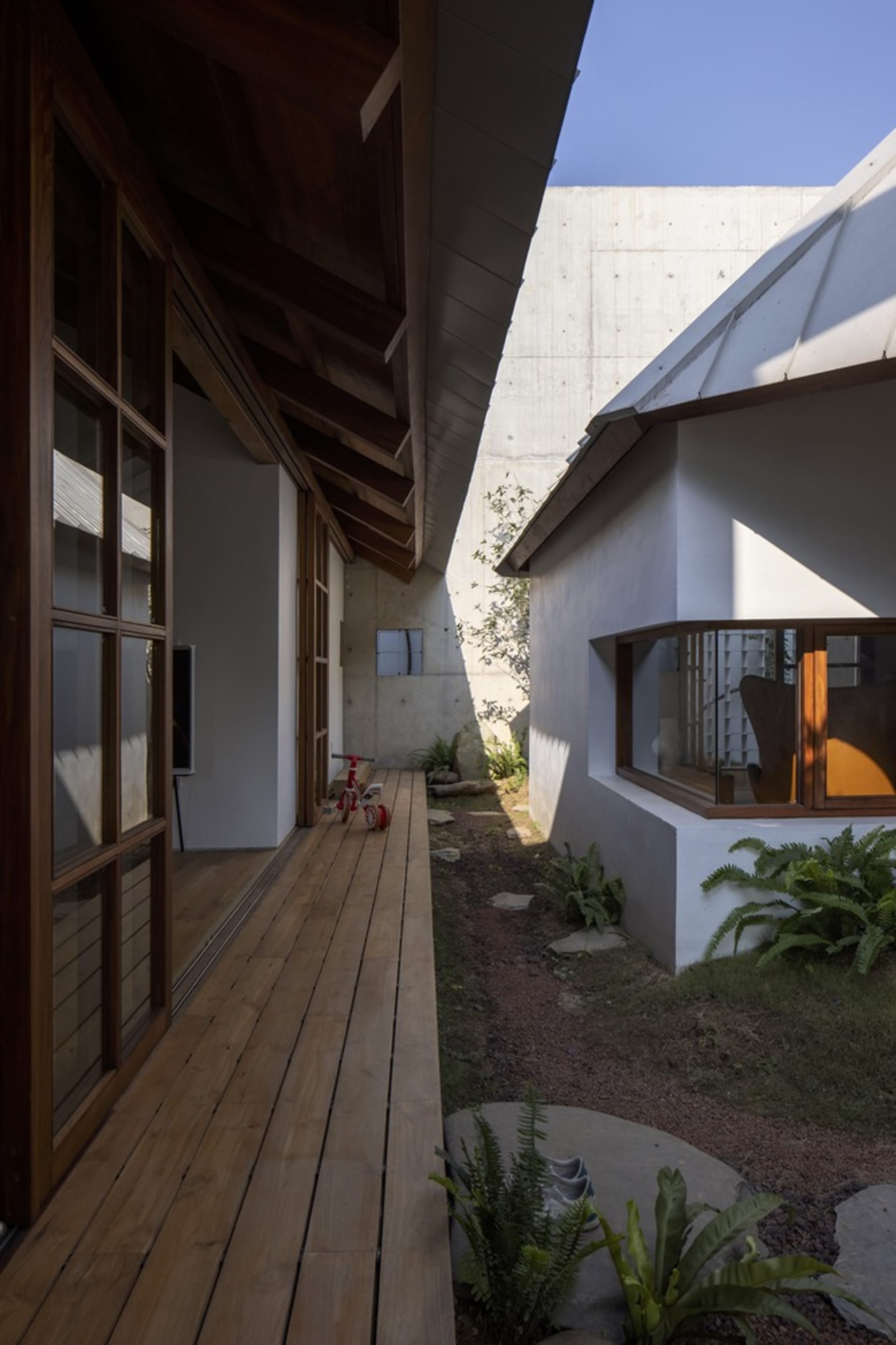 Modern house exterior featuring wooden facade and concrete wall