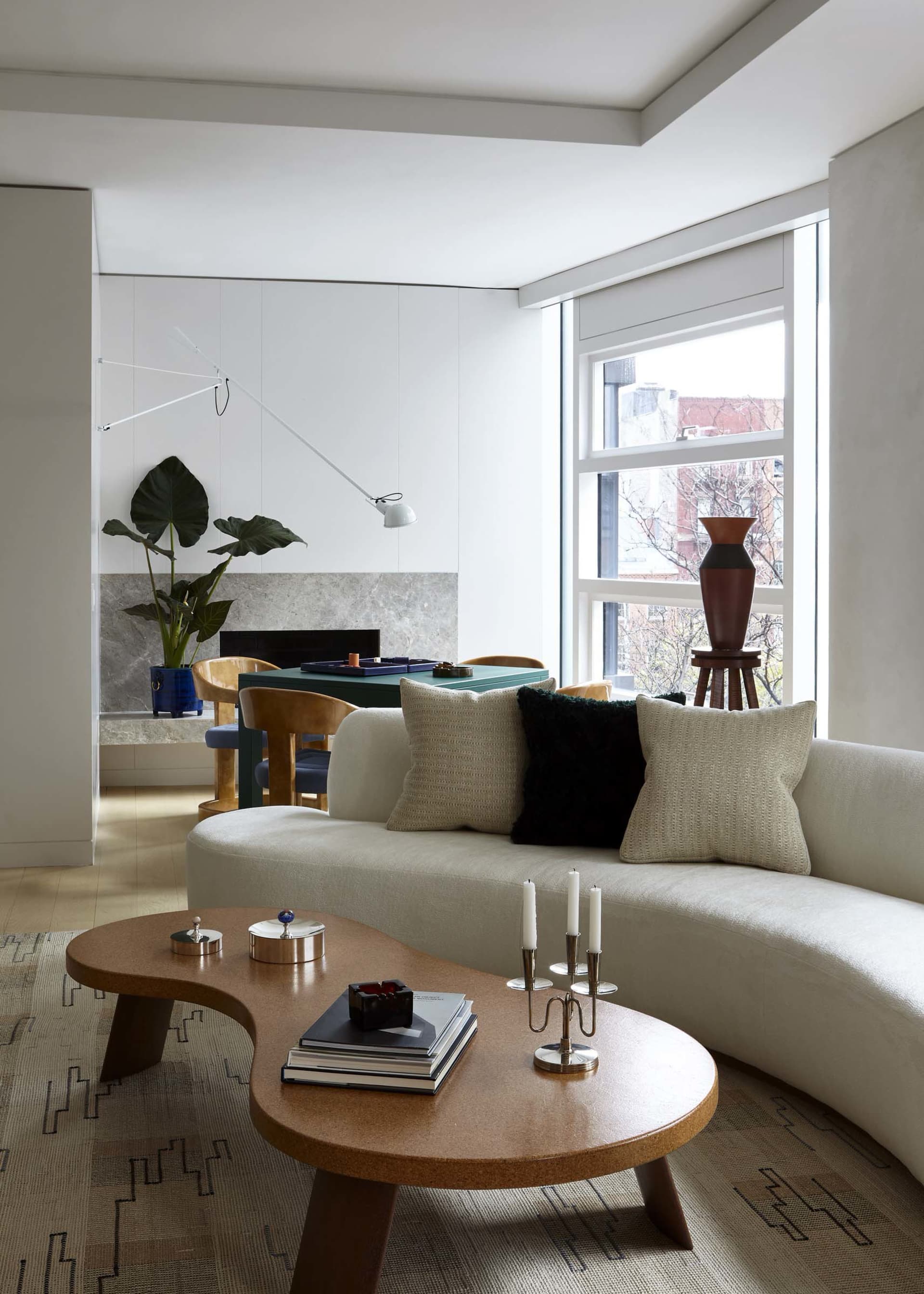 Modern minimalist residential living room with neutral colors, wood accents, and fabric furniture