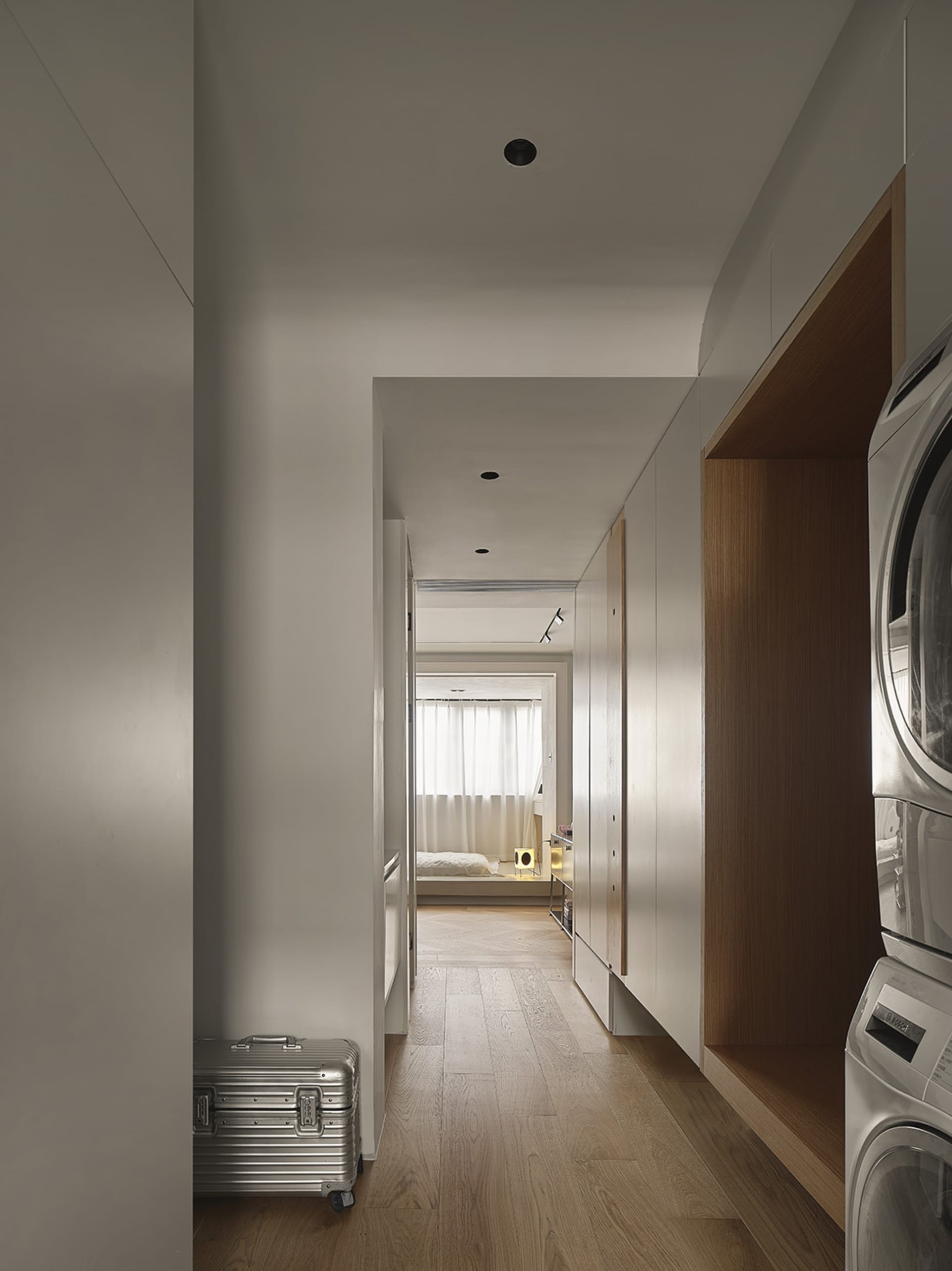 Modern closet space featuring sleek storage solutions with minimalist design and warm wooden elements.