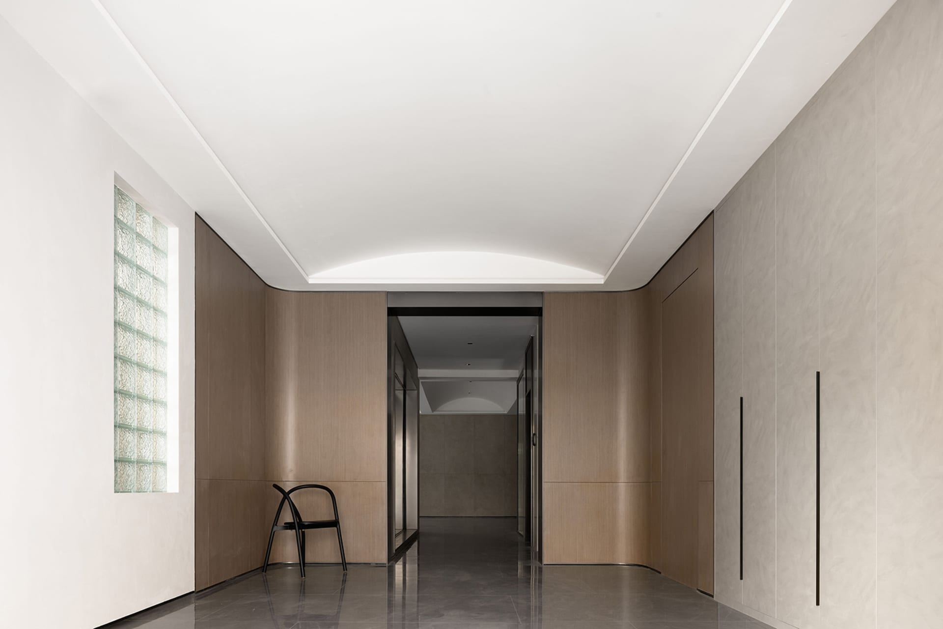 A modern interior corridor featuring wooden walls and a sleek design.