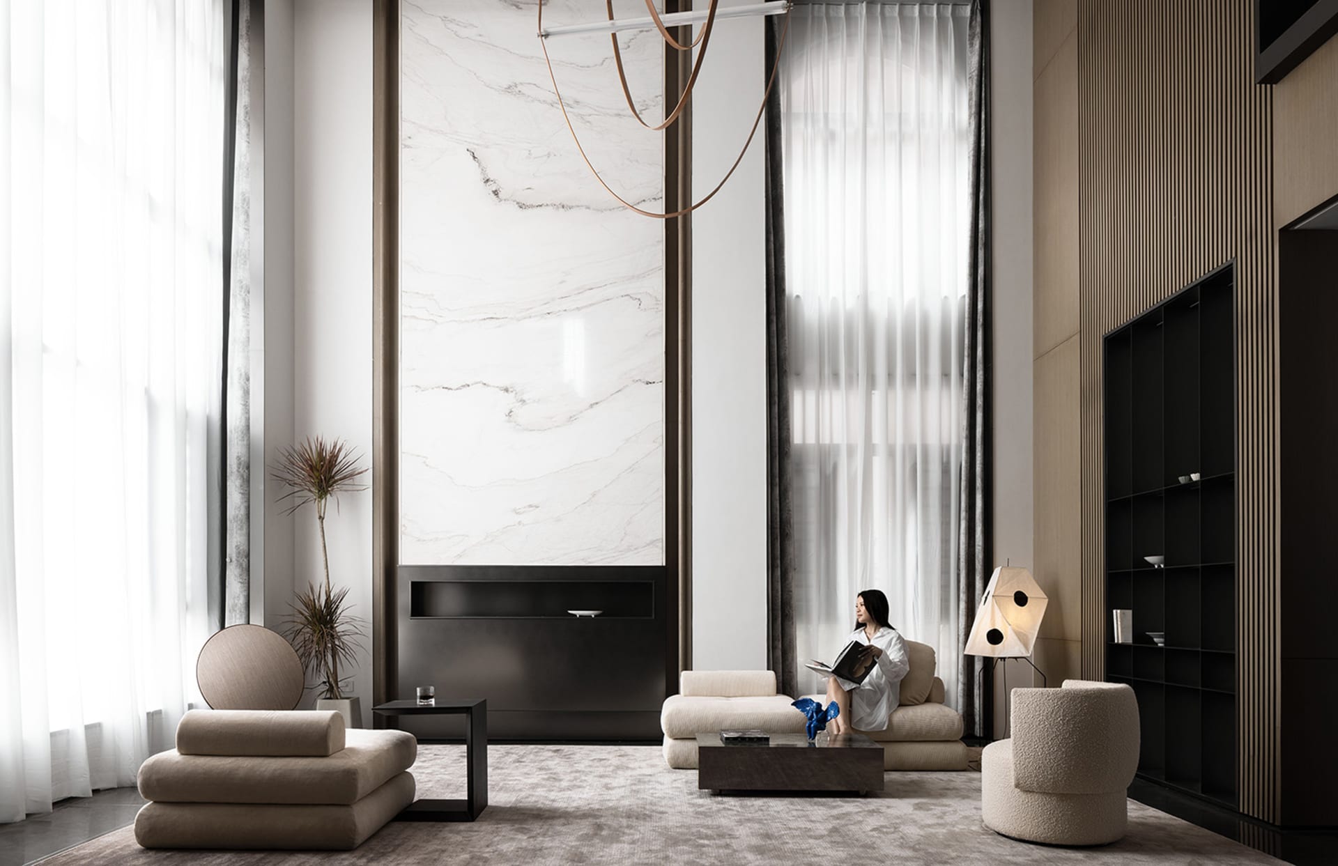 A modern living room featuring marble, concrete, and textured fabric materials.