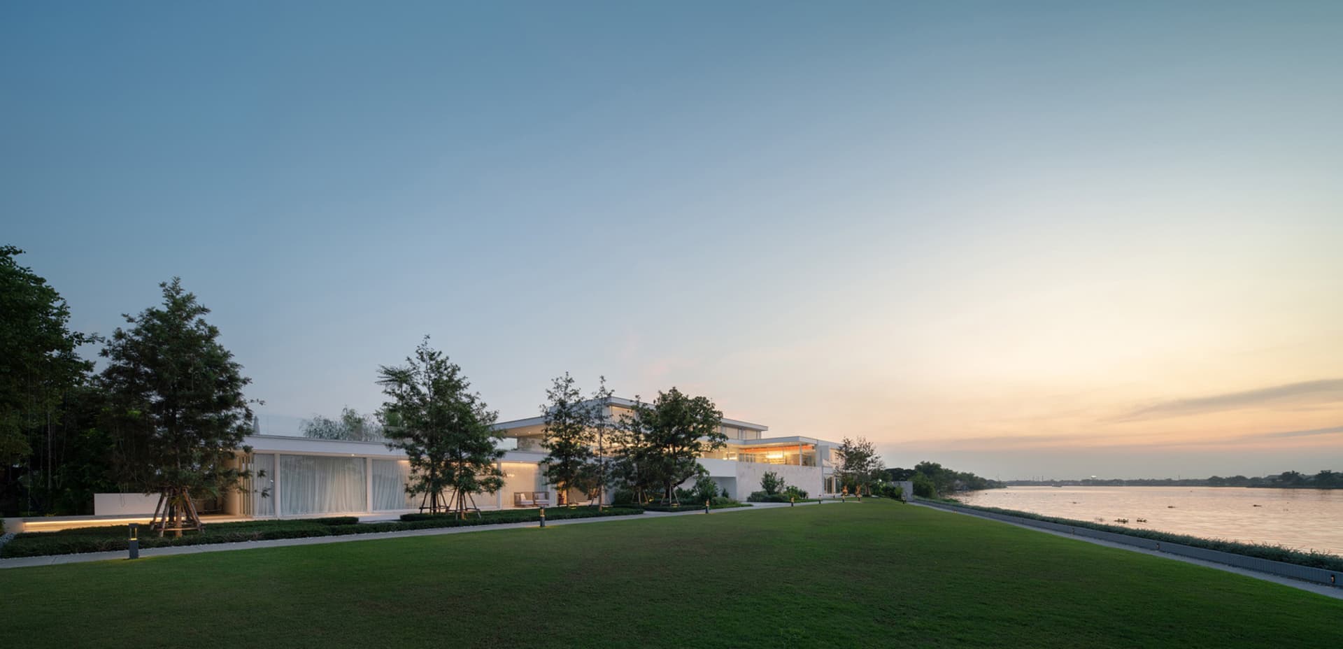 Modern residential architecture featuring glass and concrete materials.