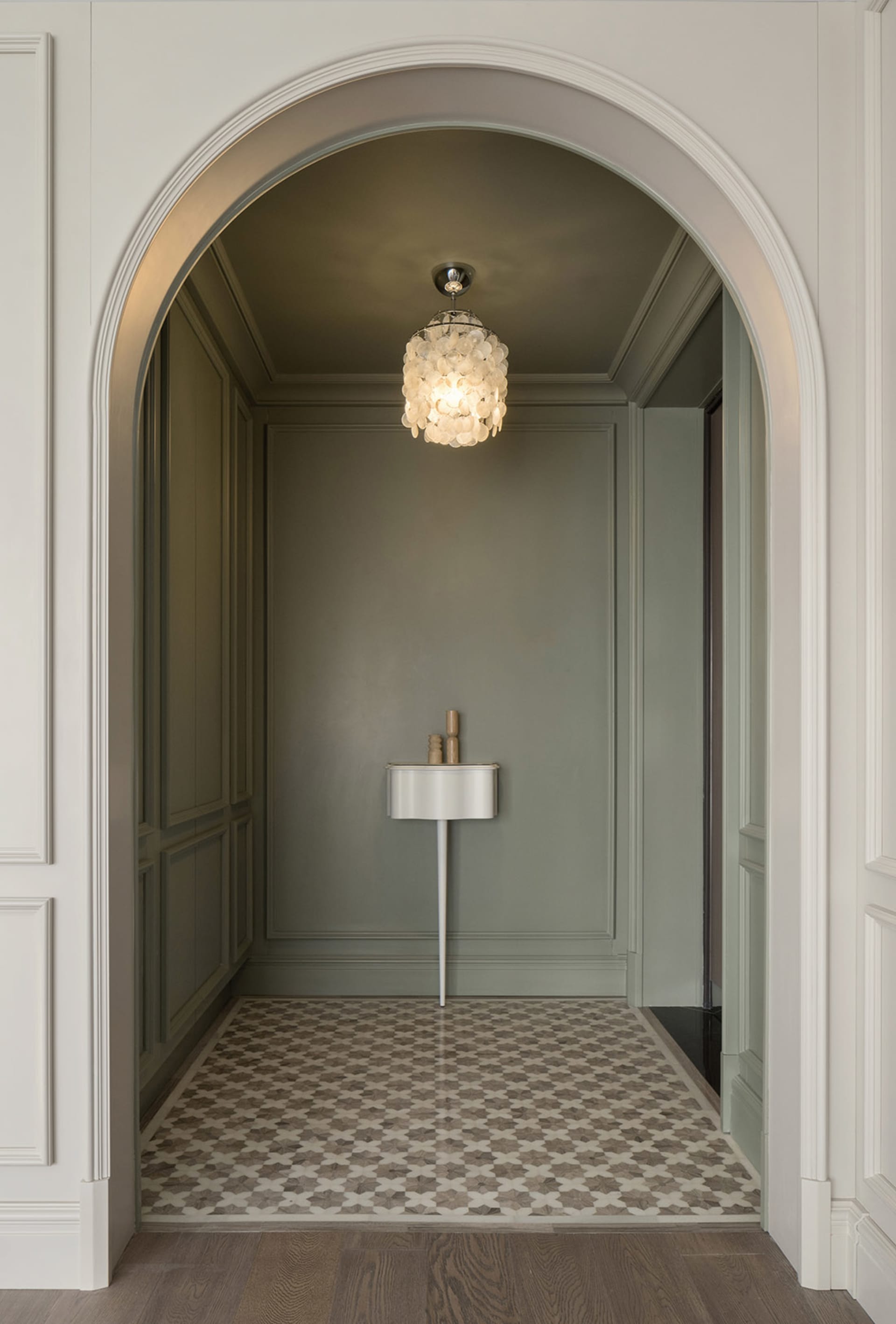 Modern bathroom featuring white walls, a patterned tile floor, and a minimalist design.