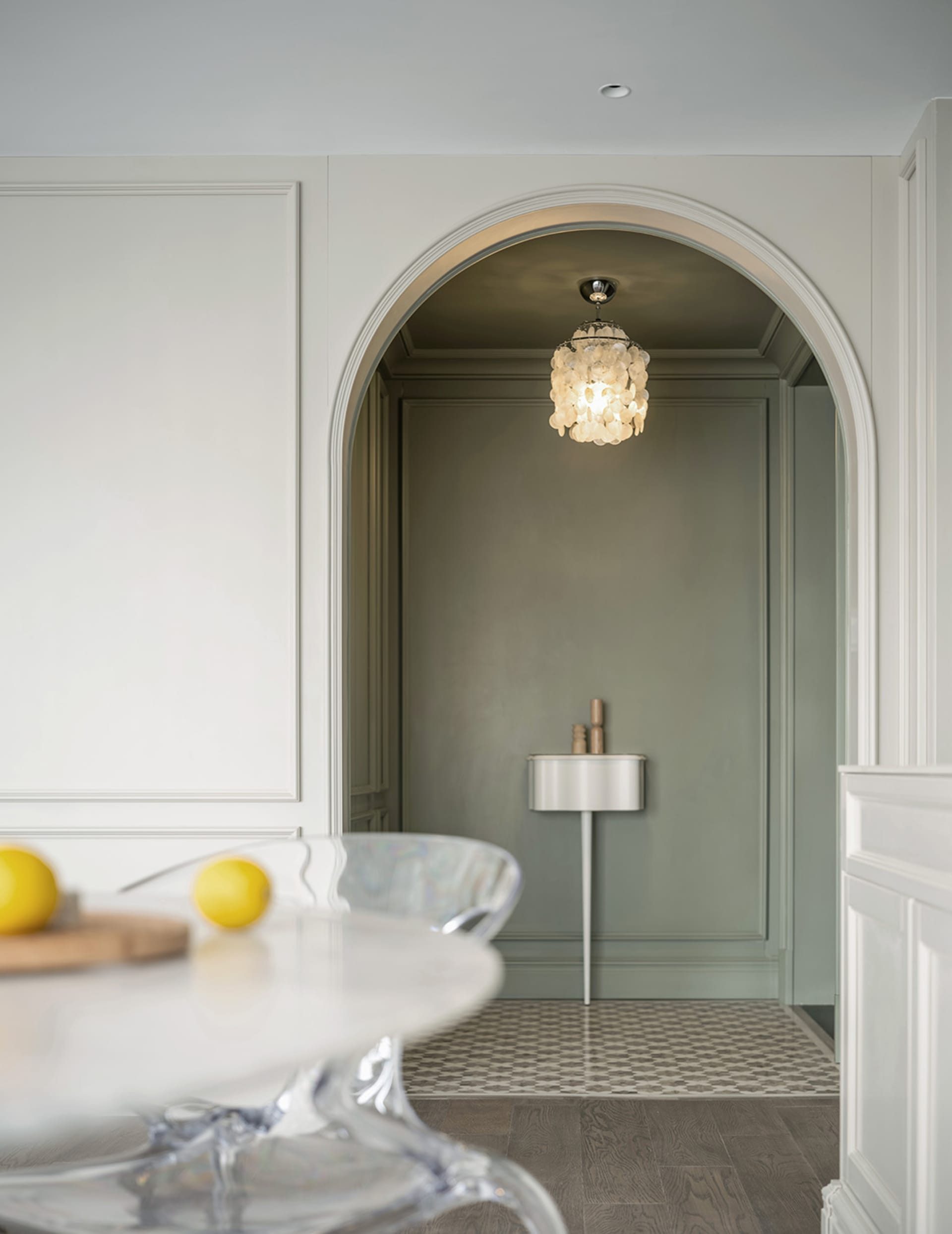 A modern minimalist kitchen with a glass countertop, featuring sleek lines and a clean, uncluttered design.