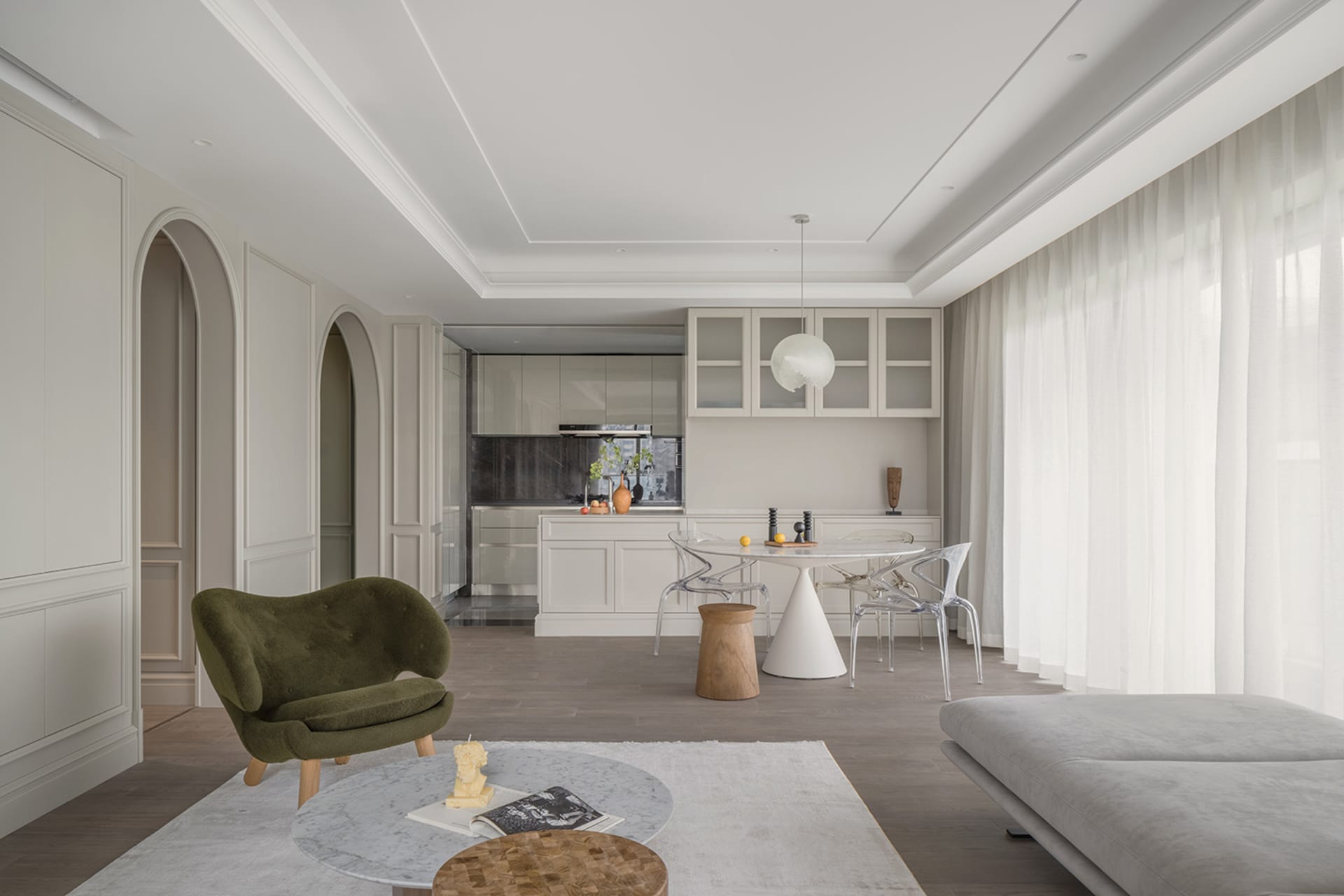 A modern apartment featuring a living room, kitchen, and dining area with minimalist design.