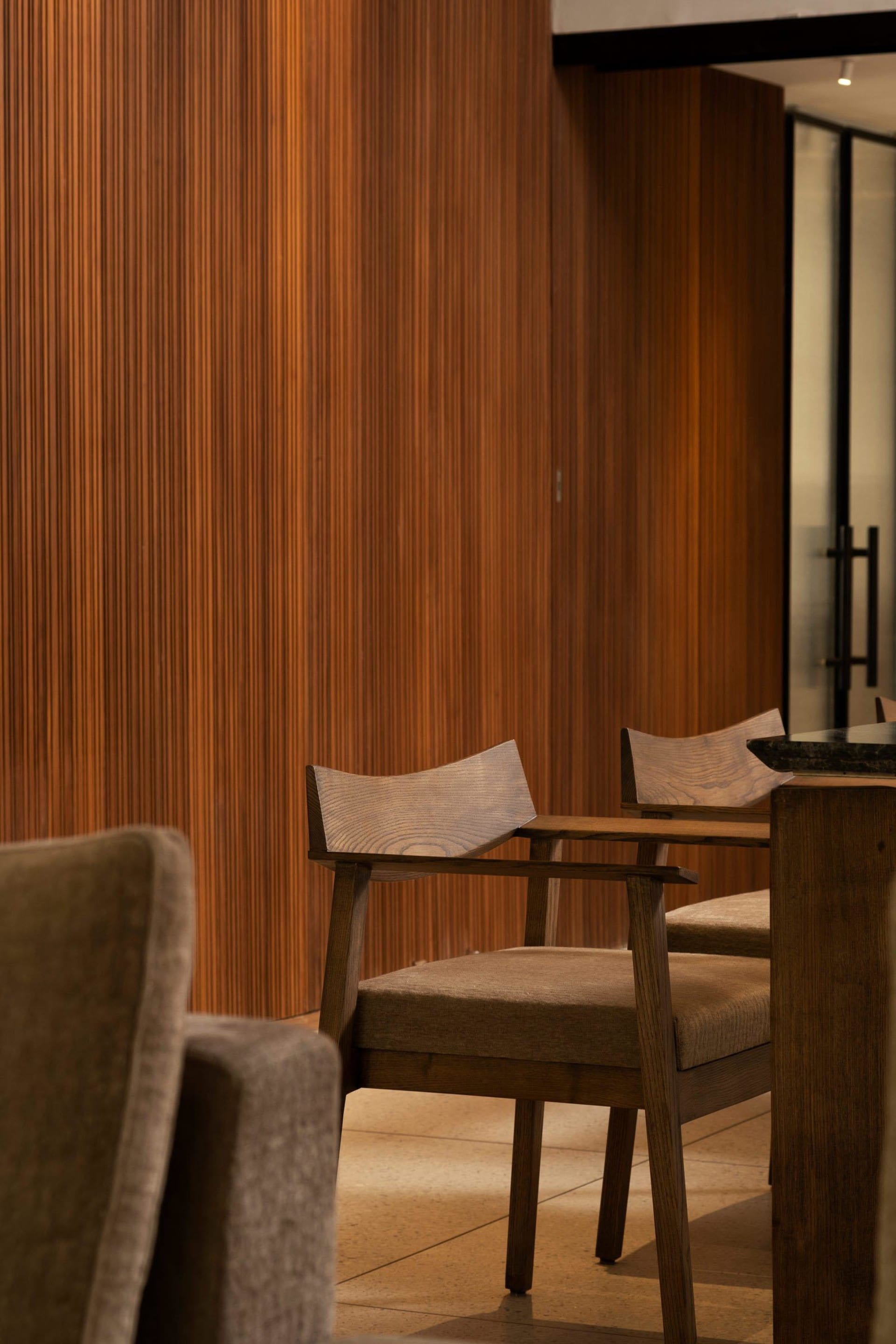 Modern restaurant interior with wooden furniture and seating.