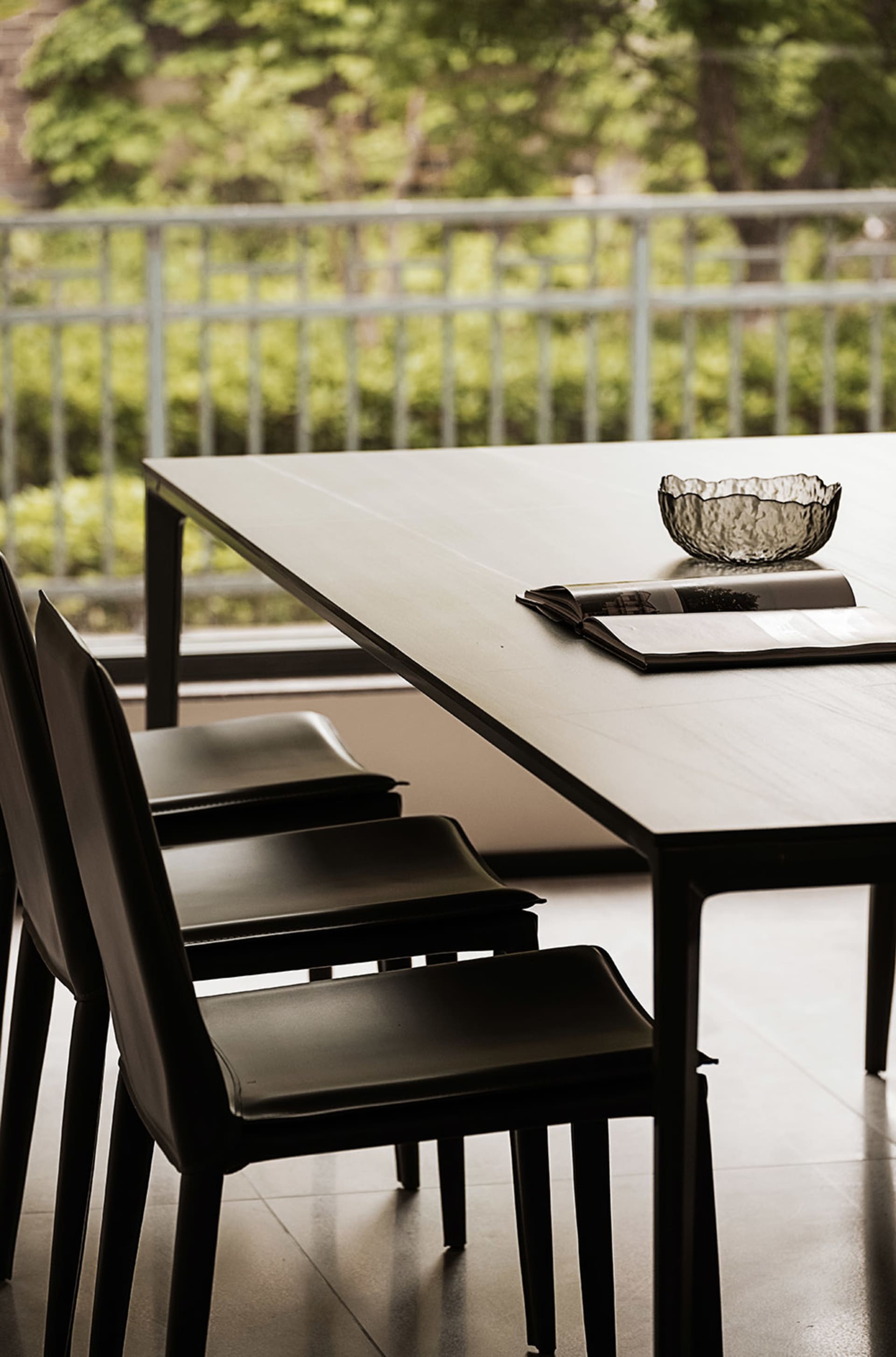 A modern dining room featuring chairs with composite materials and a table with a minimalist design.
