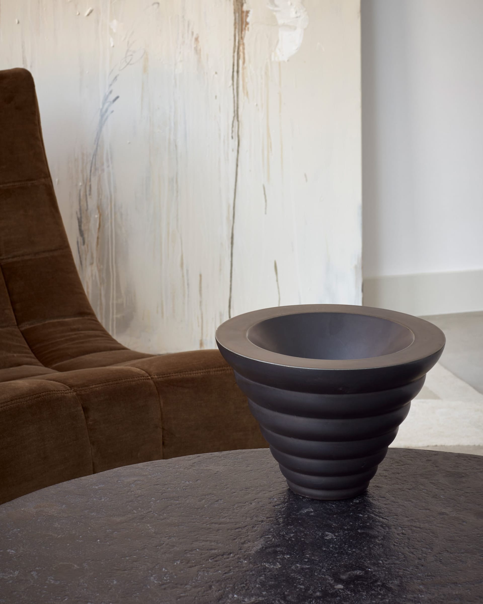 A modern living room with textured plaster walls and a minimalist design aesthetic.