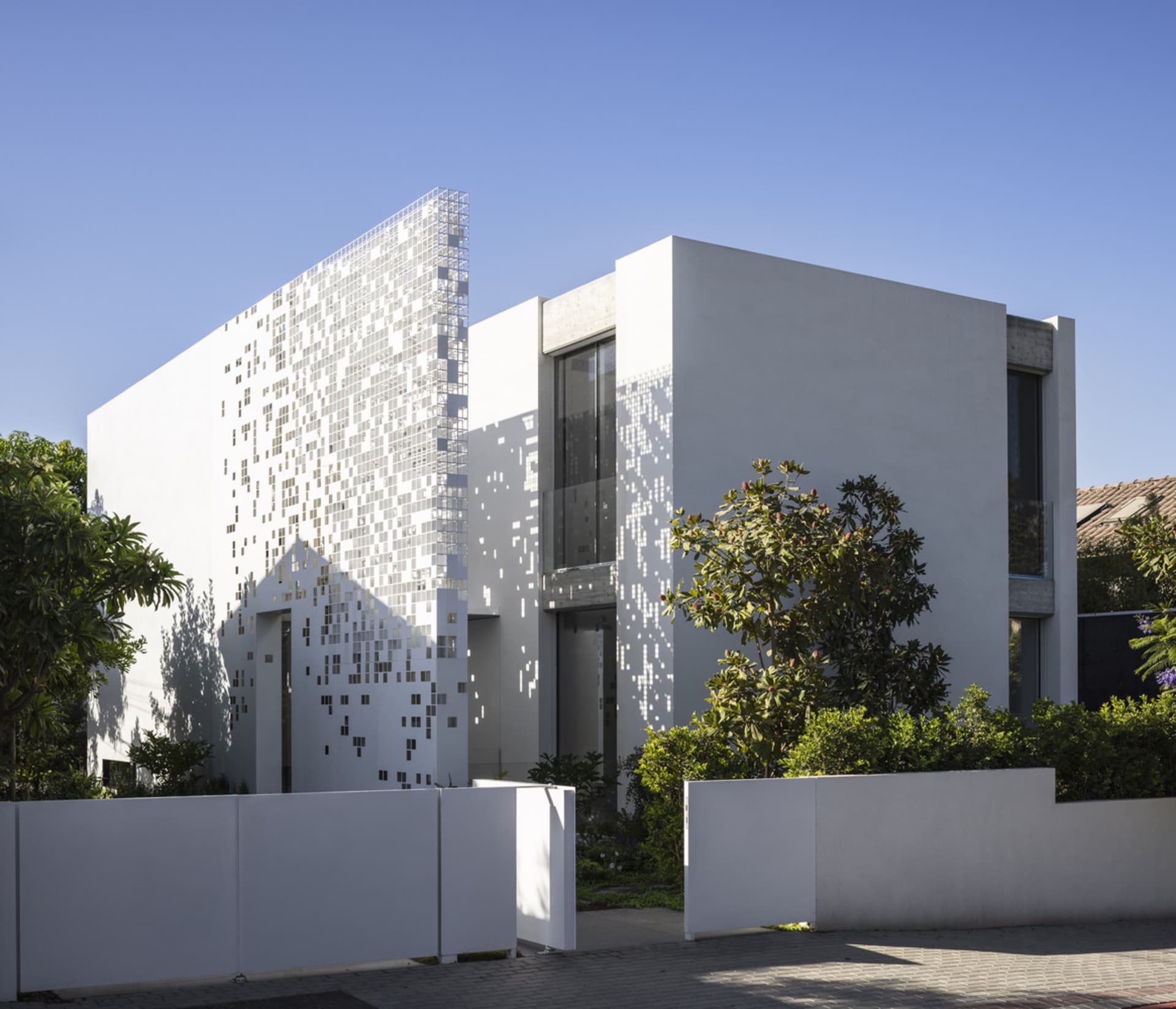 A modern house with a mix of glass and concrete exterior materials.
