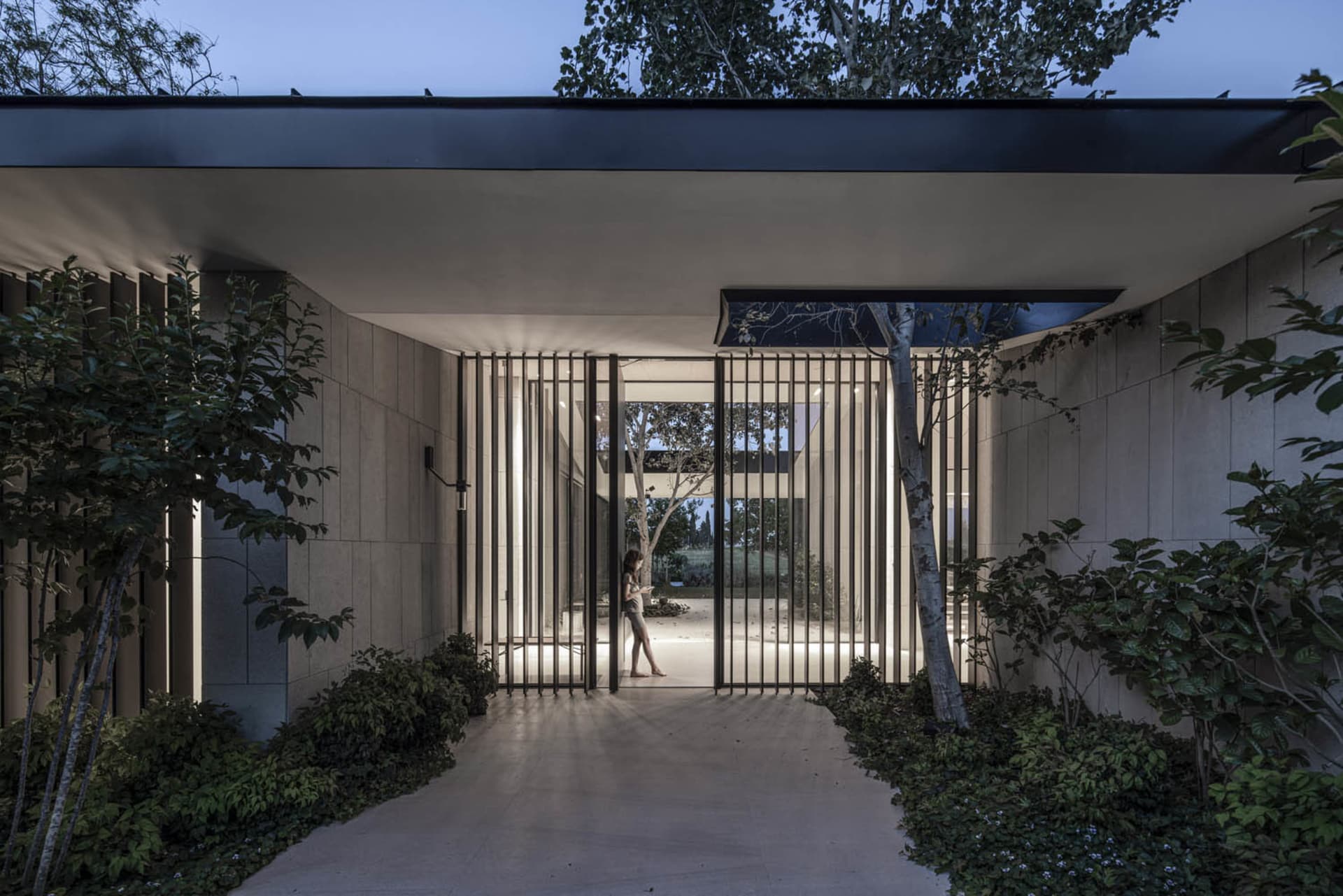 Modern entrance with metal railings and a path.