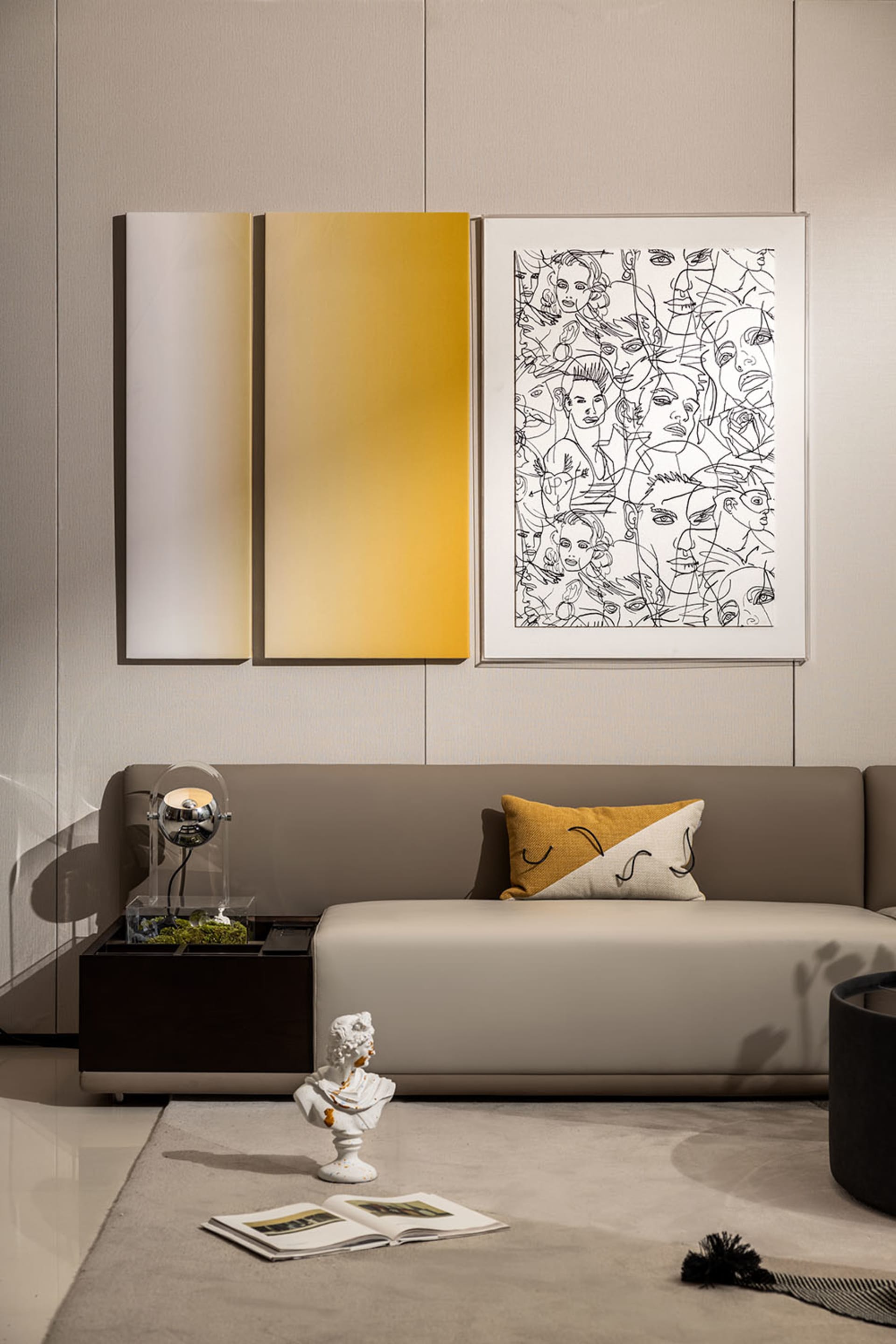 Contemporary living room with a gray sectional sofa, abstract art, and minimalist decor.