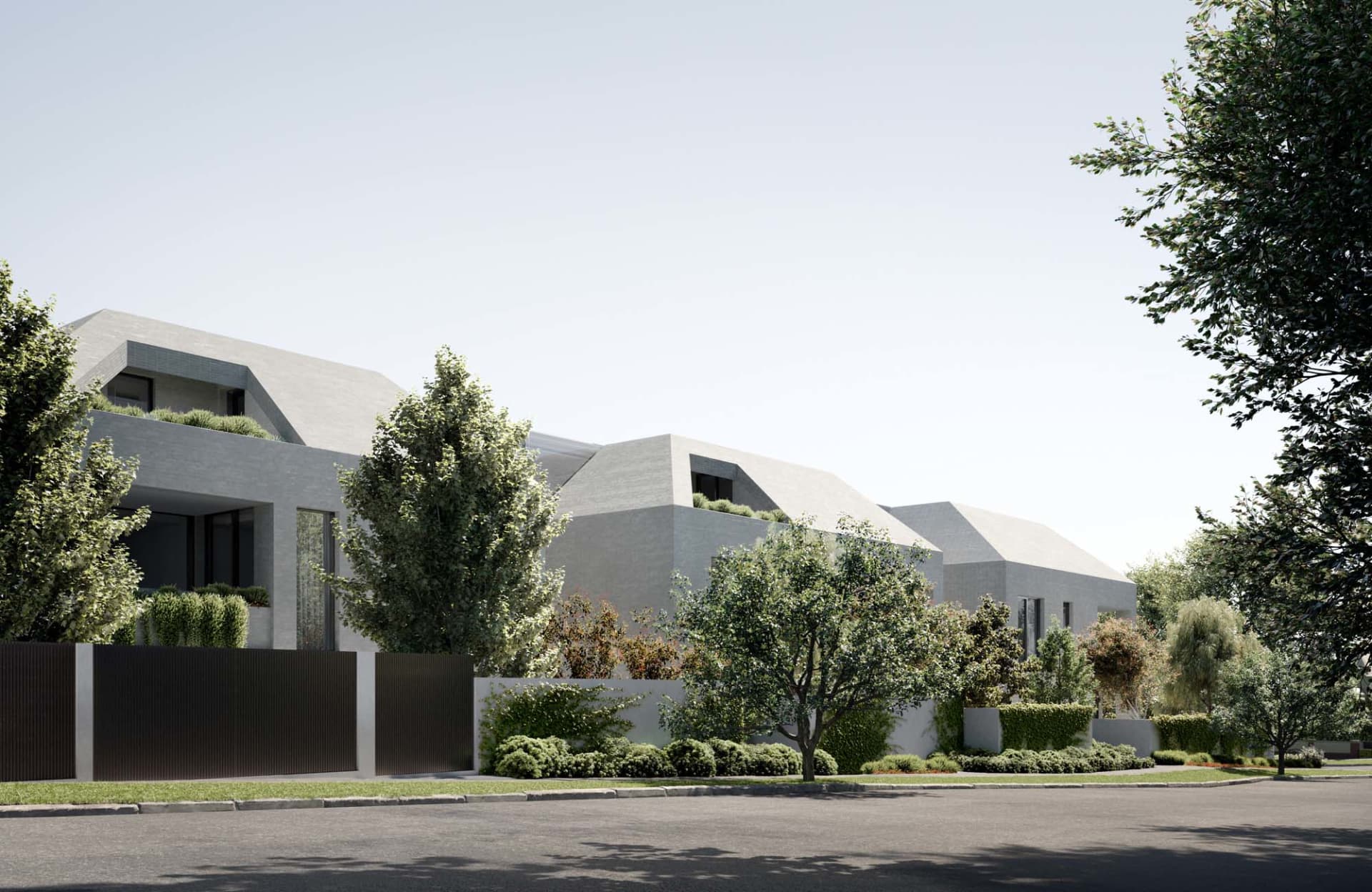 A modern residential exterior with concrete walls and a sloped roofline, surrounded by green foliage and a well-maintained la