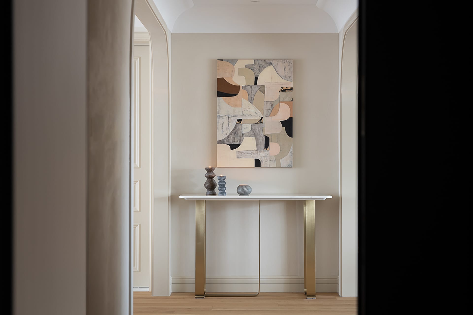 A modern console table adorned with contemporary abstract art in a minimalistic interior